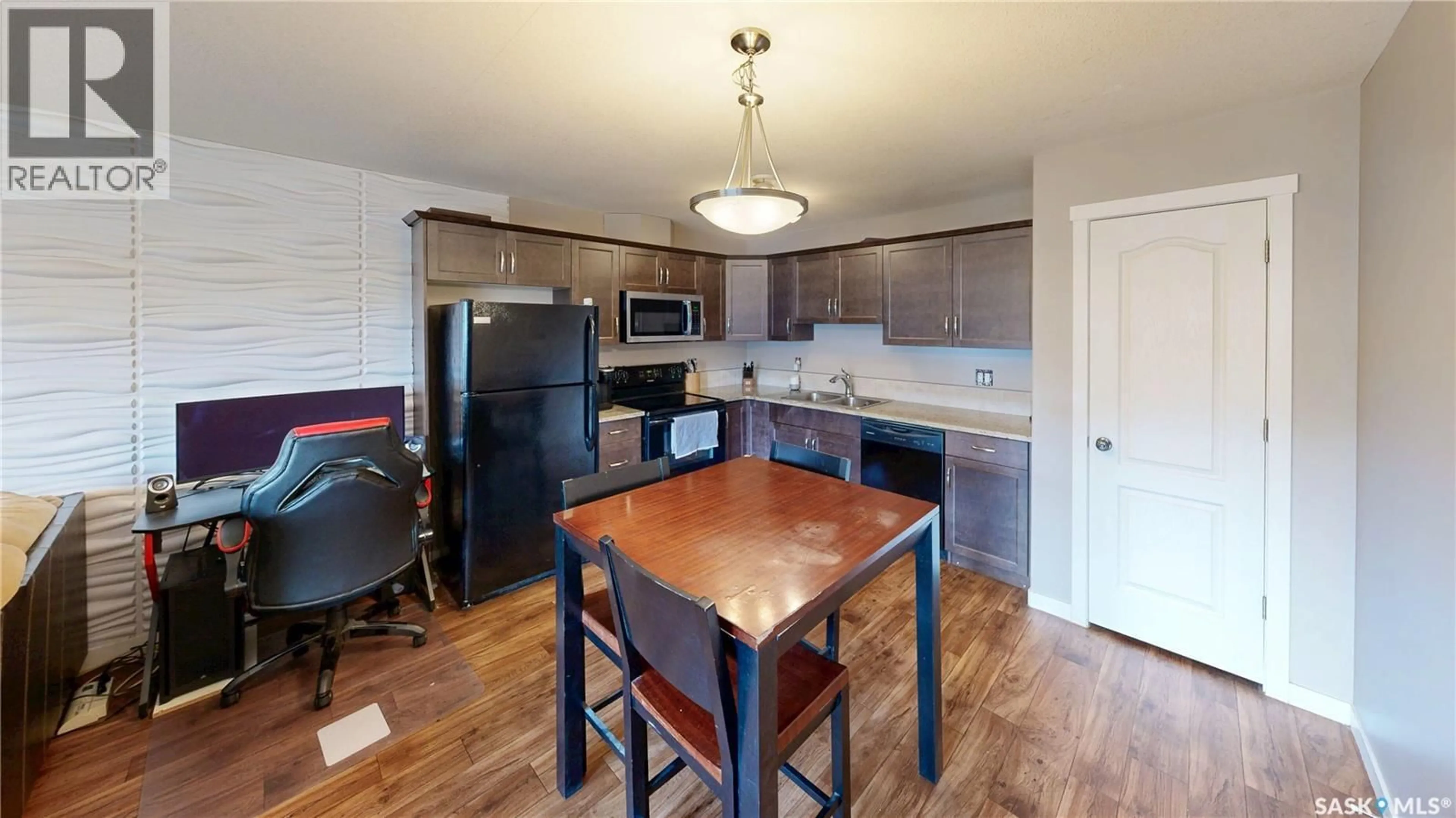 Open concept kitchen, wood/laminate floor for 216 1220 EMPRESS STREET, Regina Saskatchewan S4T1G7