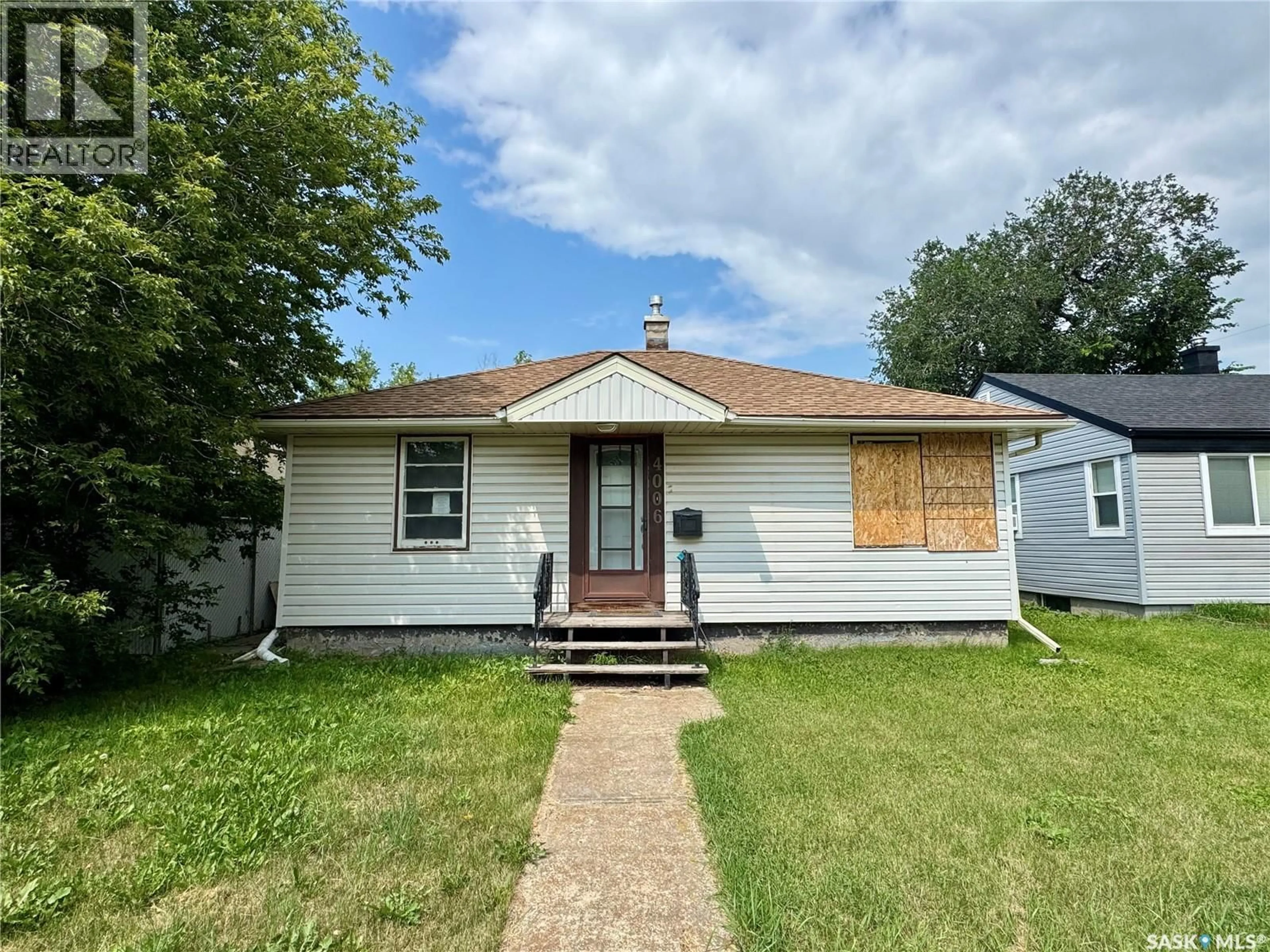 Home with vinyl exterior material, street for 4006 4TH AVENUE, Regina Saskatchewan S4R0V9