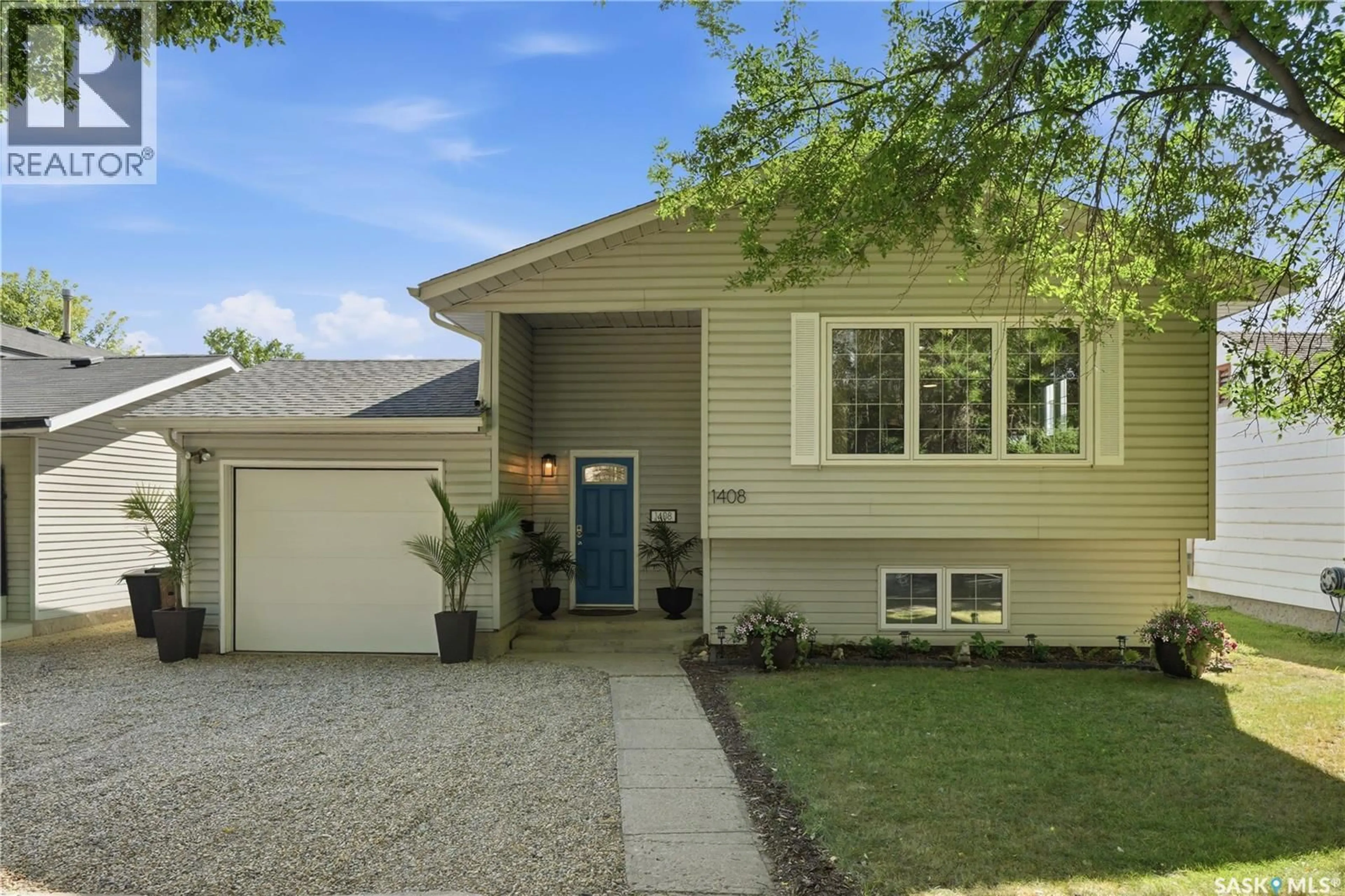 Home with vinyl exterior material, street for 1408 B AVENUE, Saskatoon Saskatchewan S7L1G8