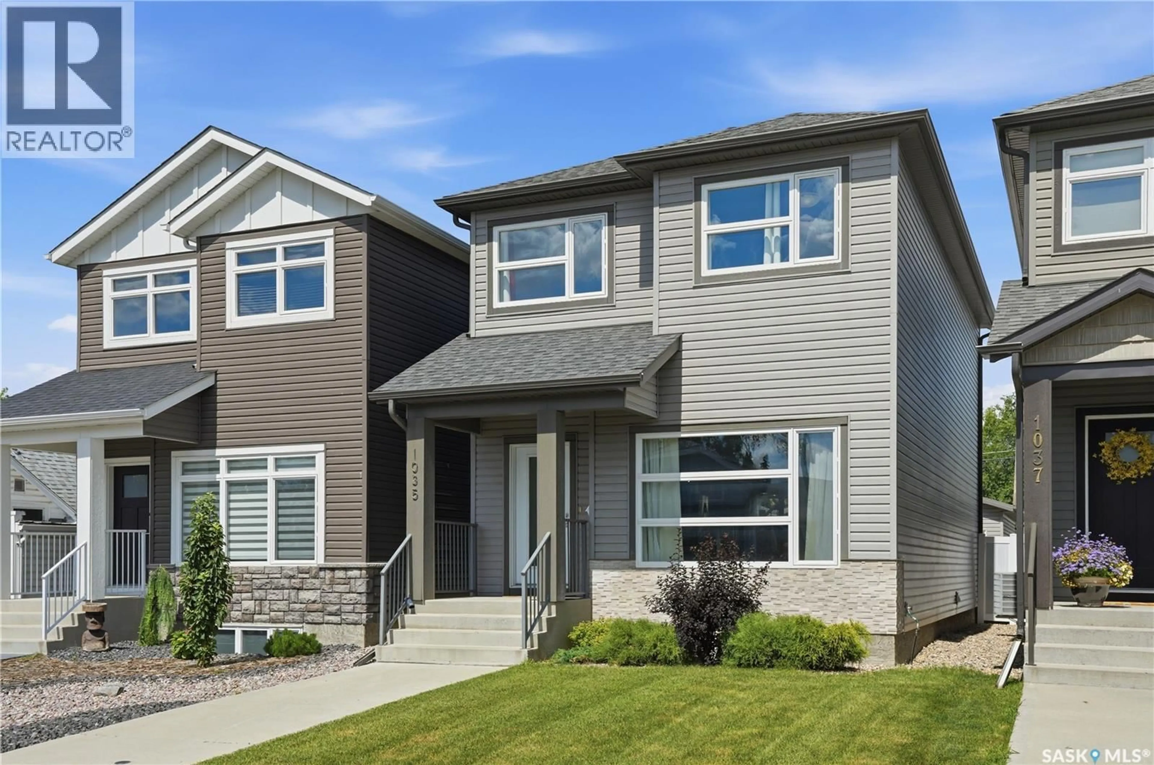 Home with vinyl exterior material, street for 1035 3RD STREET, Saskatoon Saskatchewan S7H1M8