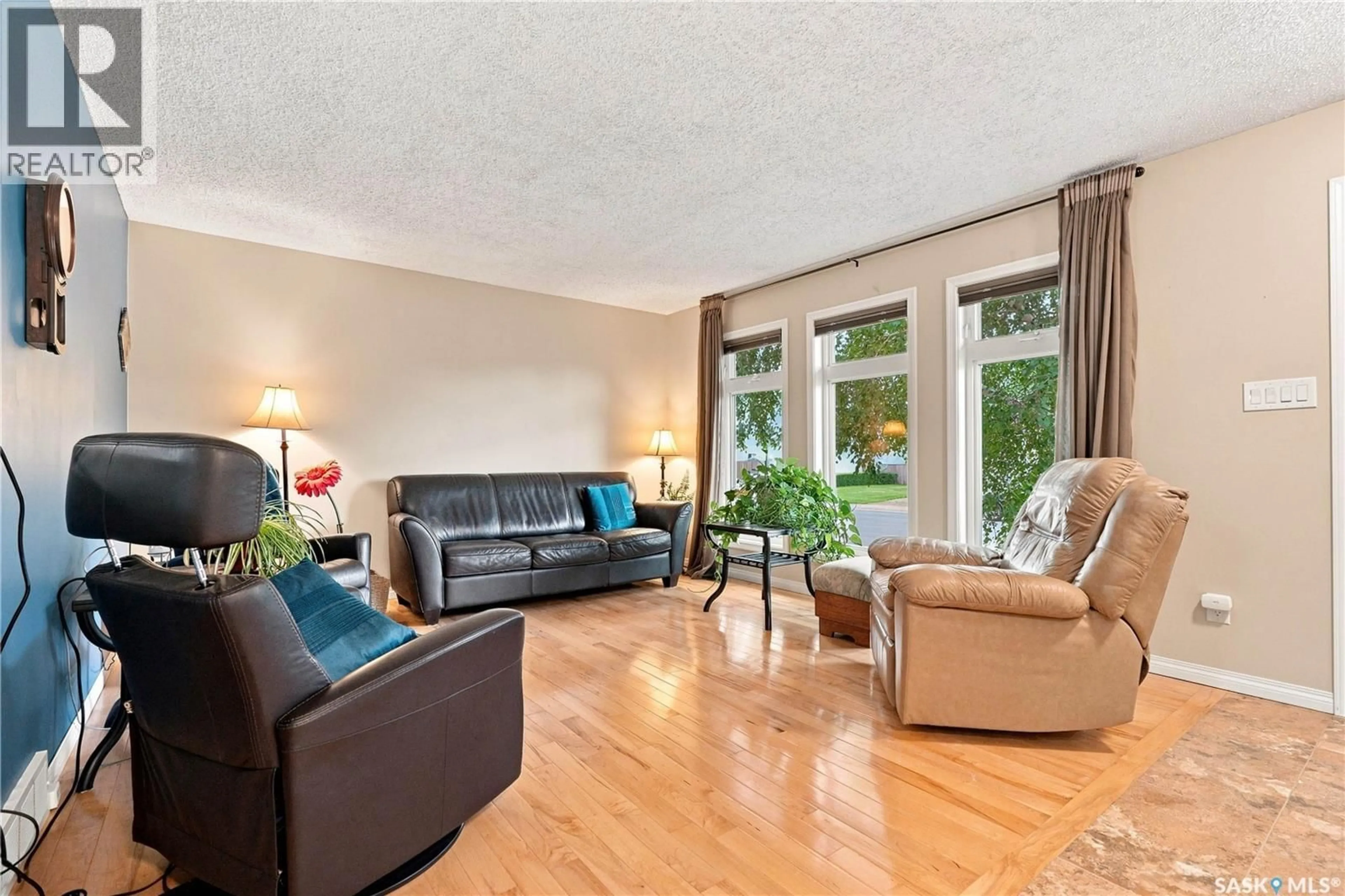 Living room with furniture, wood/laminate floor for 510 4TH STREET, Warman Saskatchewan S0K4S0