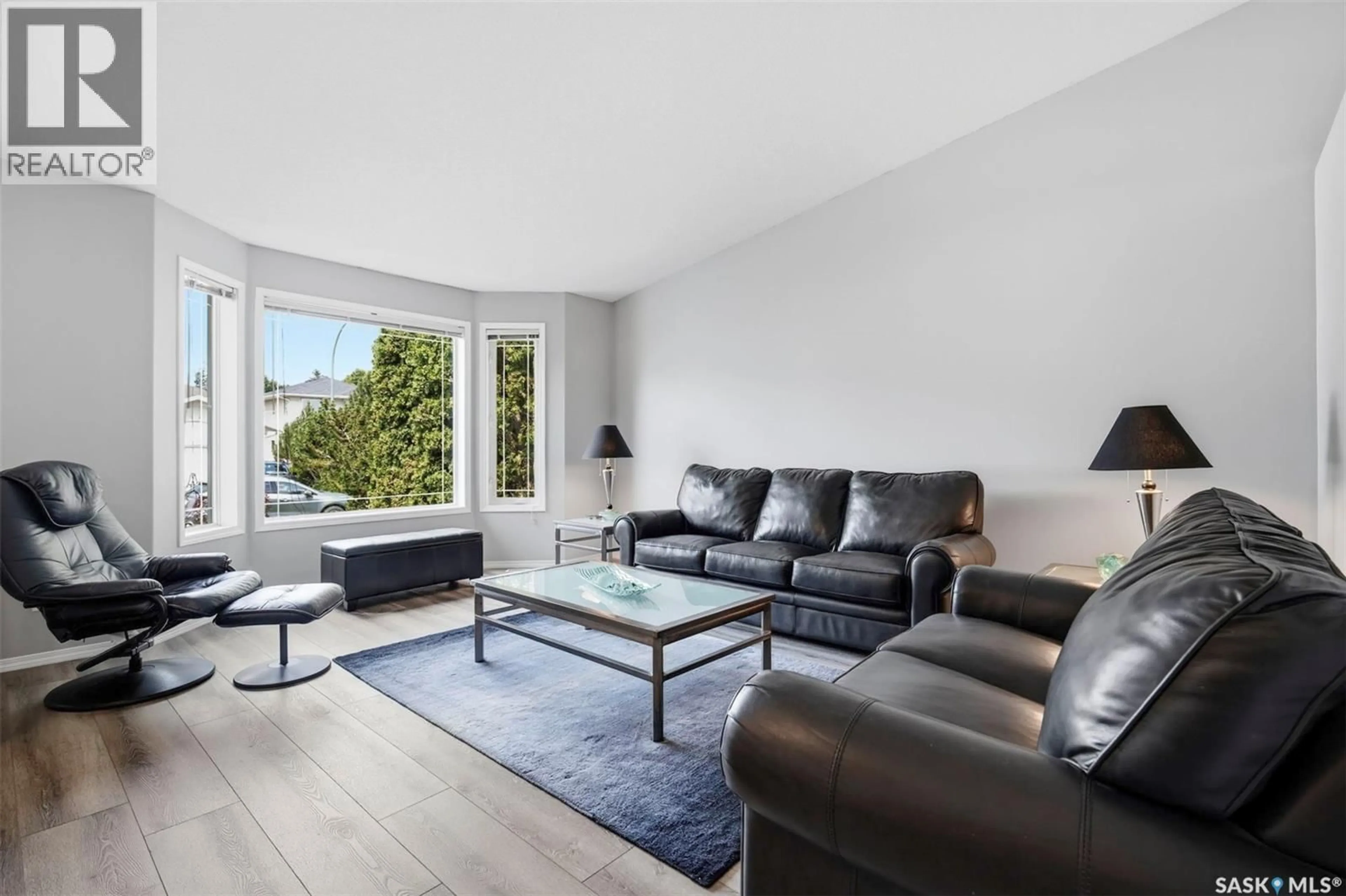 Living room with furniture, wood/laminate floor for 174 HINITT PLACE, Saskatoon Saskatchewan S7N4M6
