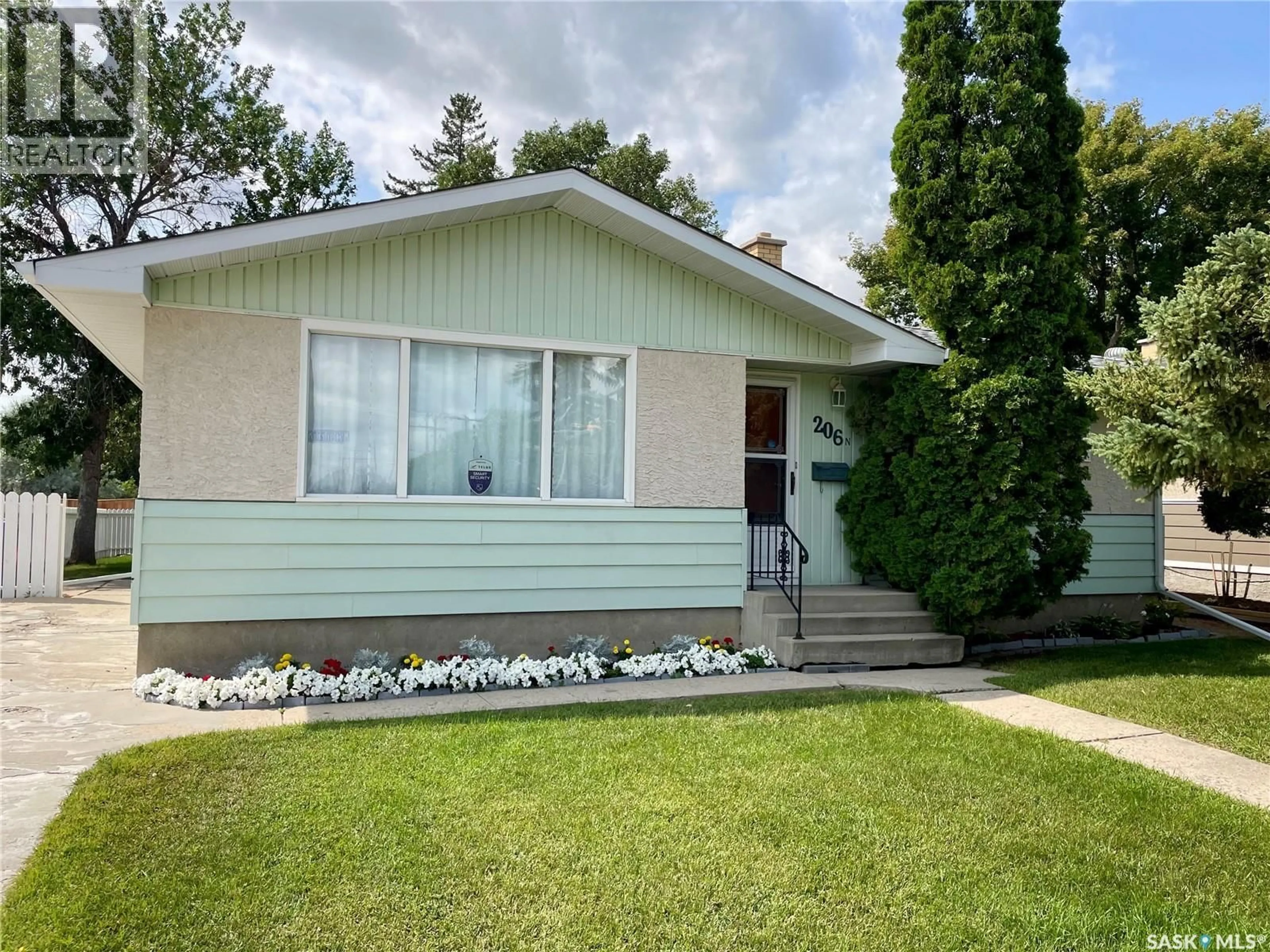 Home with vinyl exterior material, street for 206 MCINTOSH STREET, Regina Saskatchewan S4R4Z9