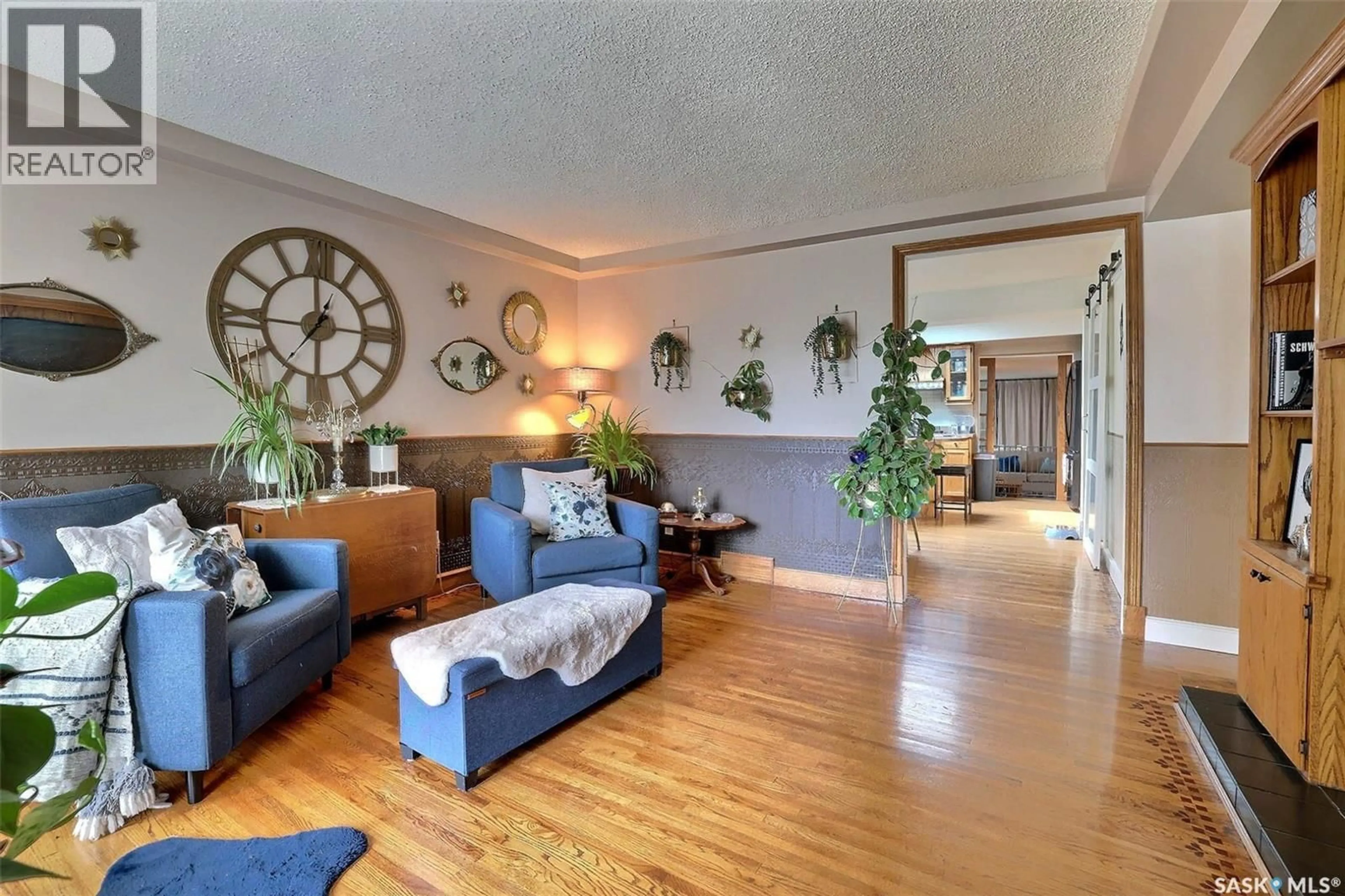 Living room with furniture, wood/laminate floor for 924 CAMPBELL STREET, Regina Saskatchewan S4T5P3