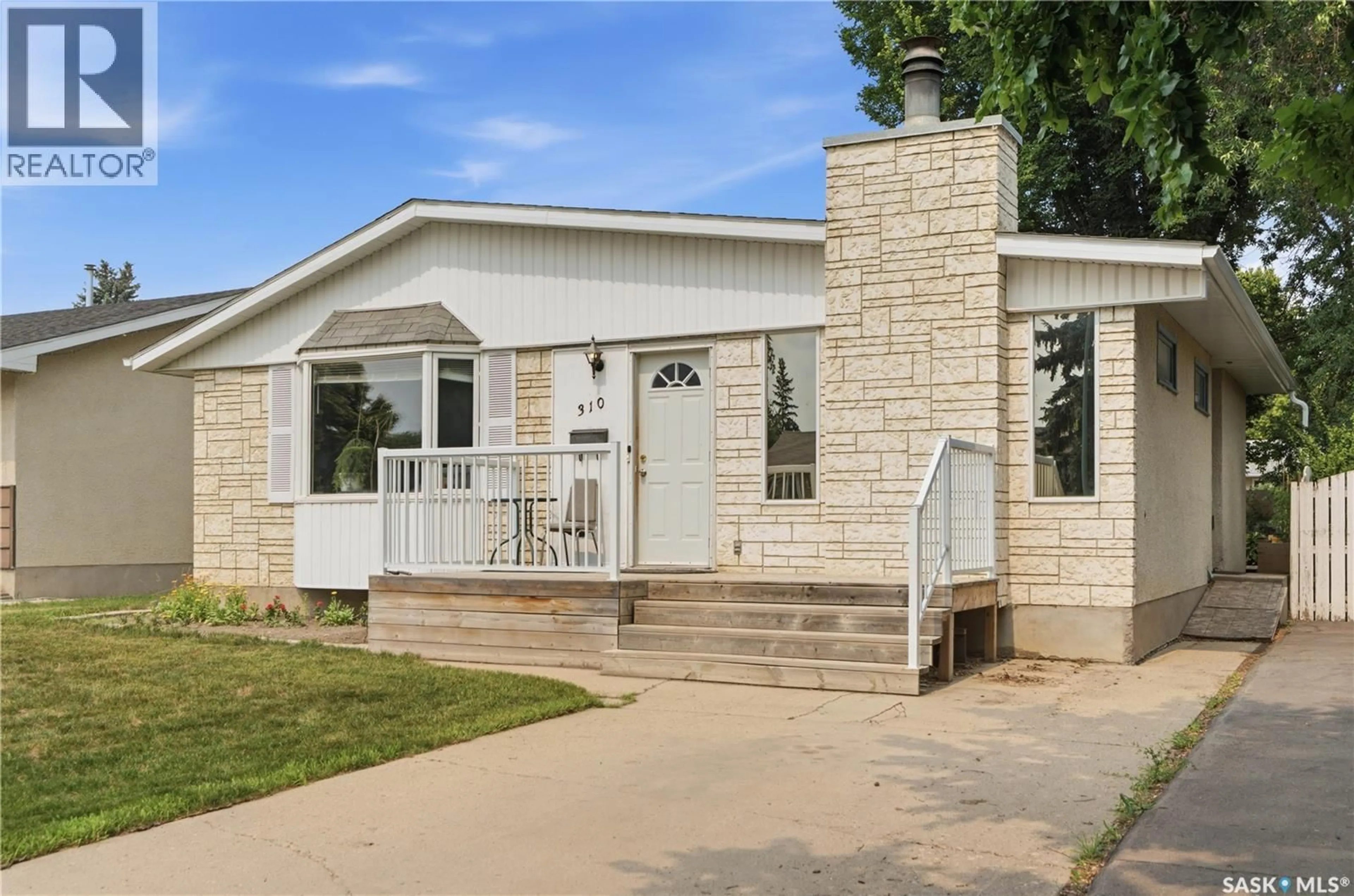 Home with vinyl exterior material, street for 310 DOUGLAS CRESCENT, Saskatoon Saskatchewan S7L4T4