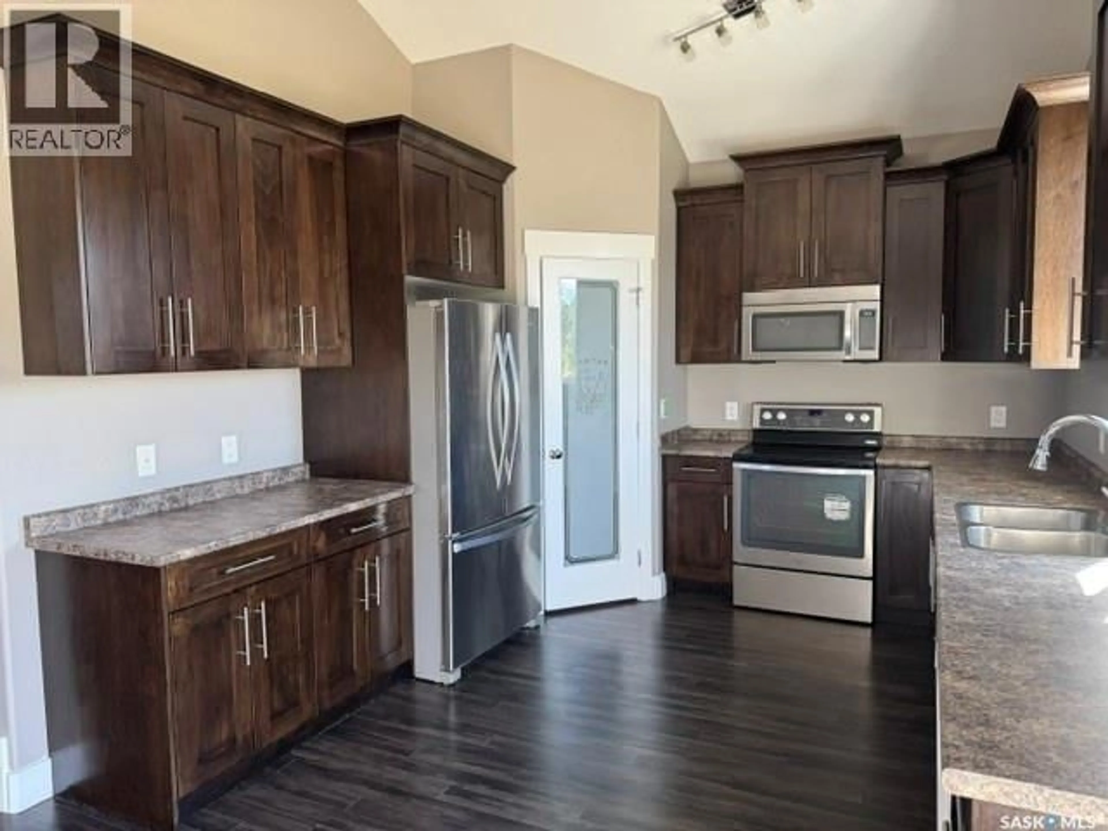 Open concept kitchen, wood/laminate floor for 281 15TH STREET, Battleford Saskatchewan S0M0E0