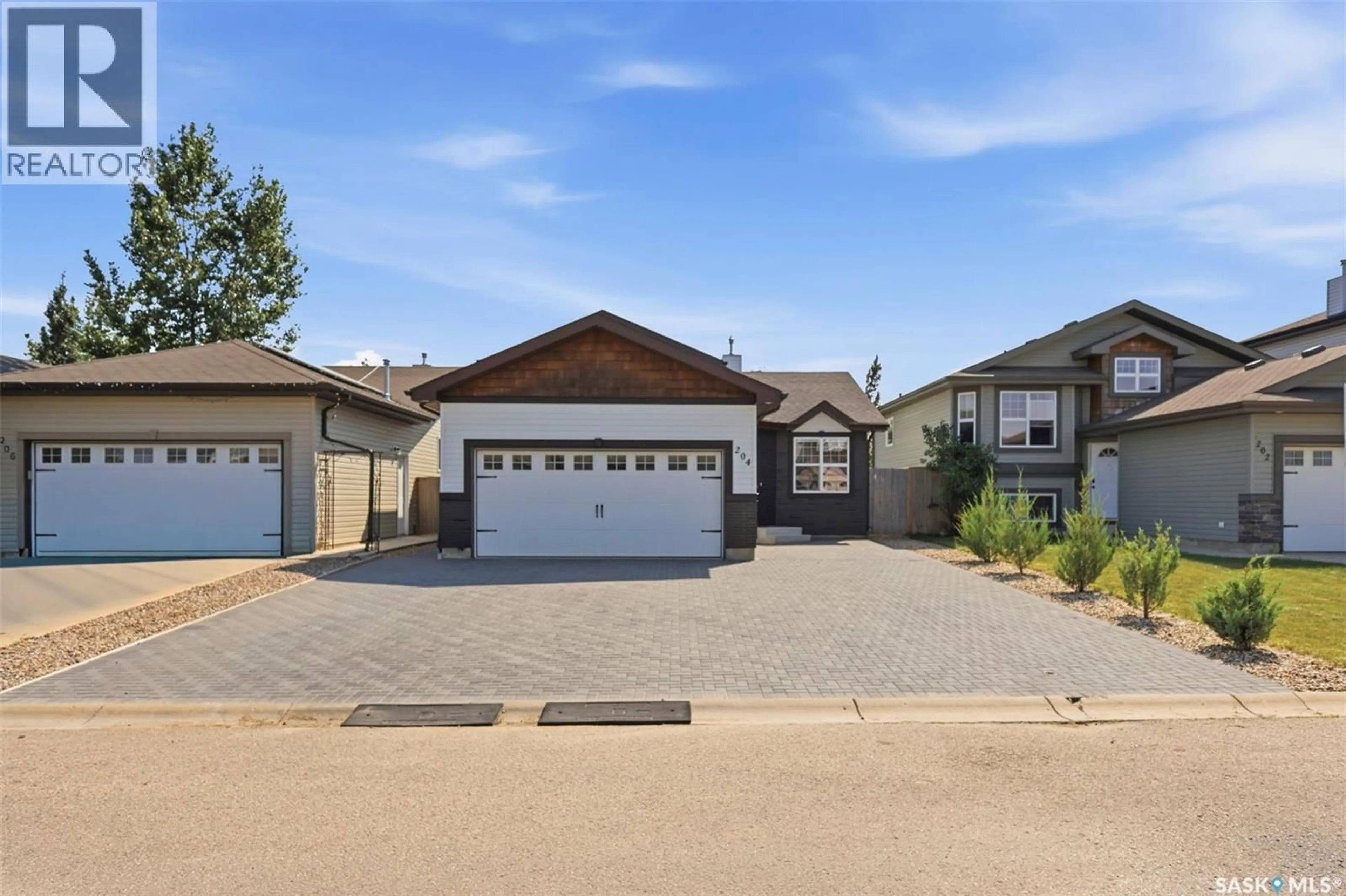 Home with vinyl exterior material, street for 204 QUESSY DRIVE, Martensville Saskatchewan S0K0A2