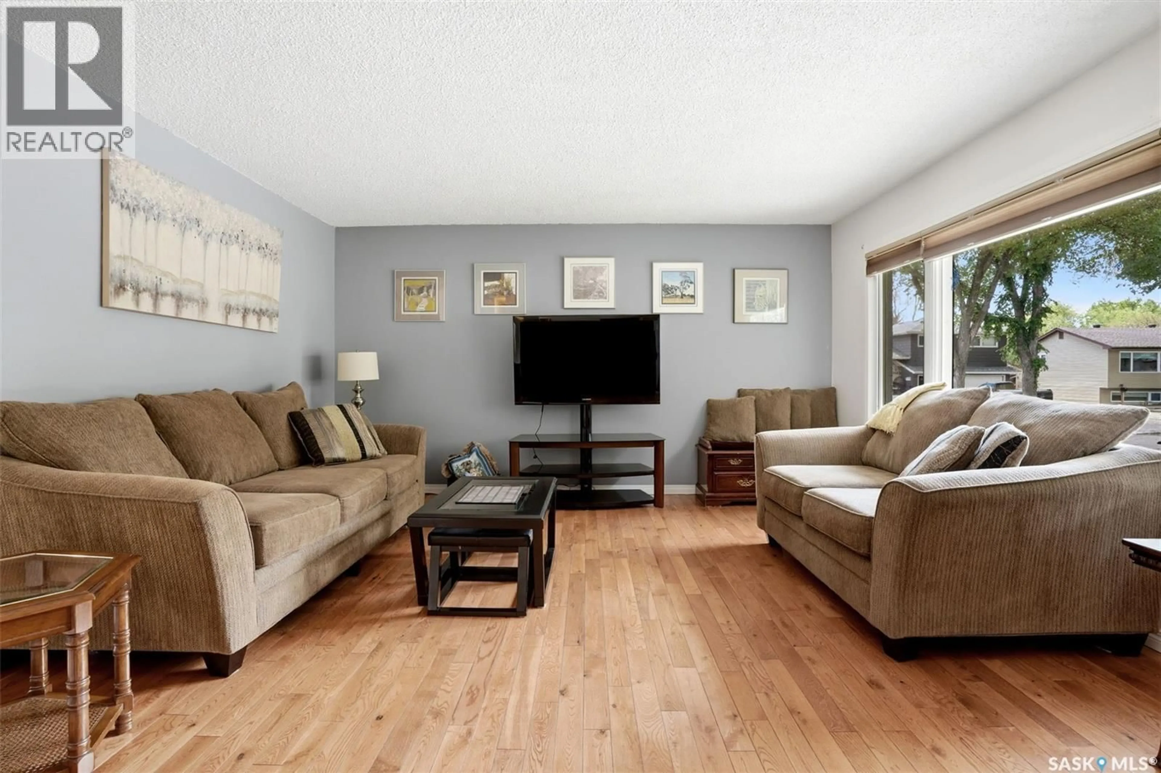 Living room with furniture, wood/laminate floor for 60 KRIVEL CRESCENT, Regina Saskatchewan S4R5C5