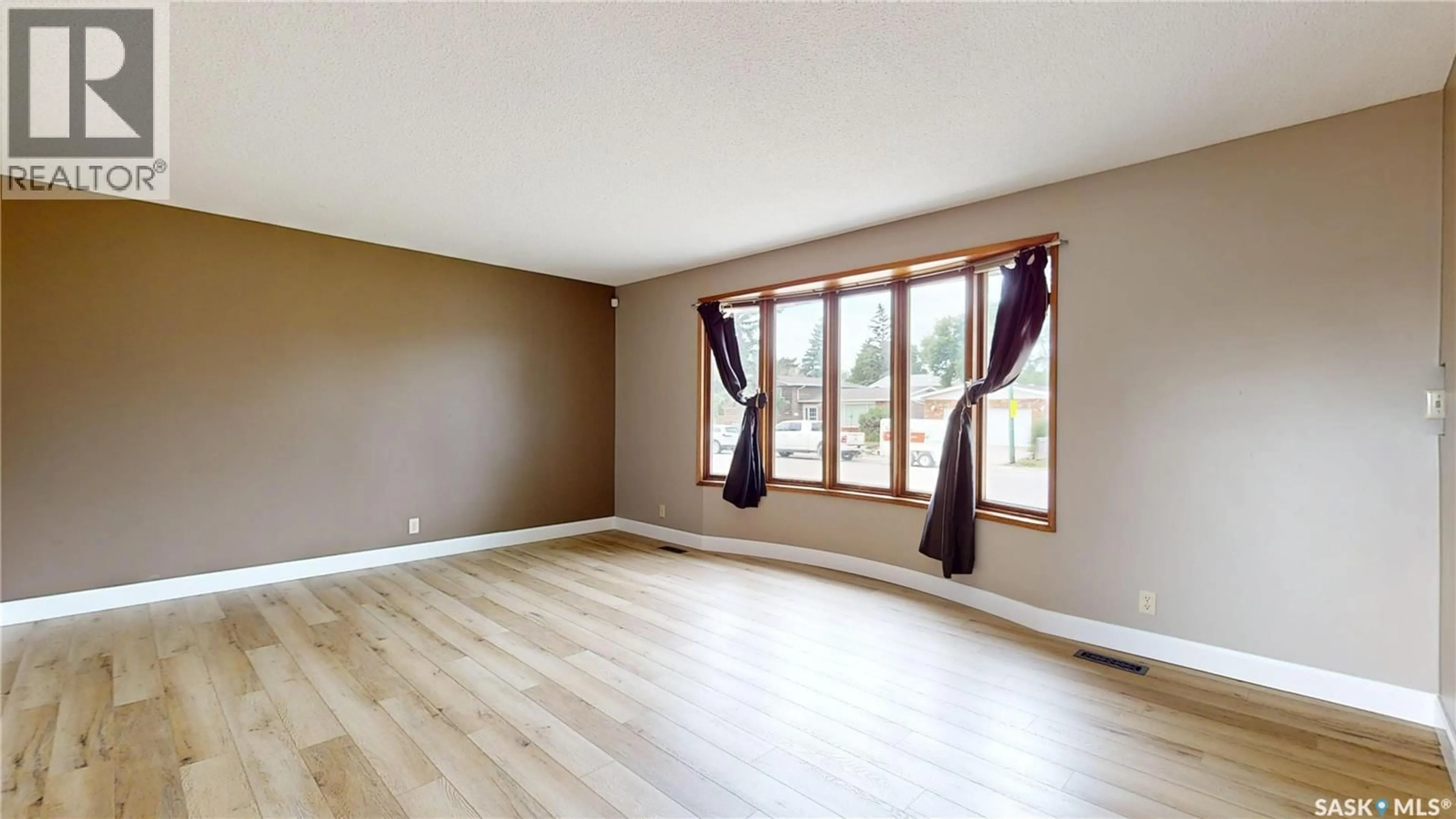 Living room with furniture, wood/laminate floor for 155 WELLS STREET, Regina Saskatchewan S4R5Z5
