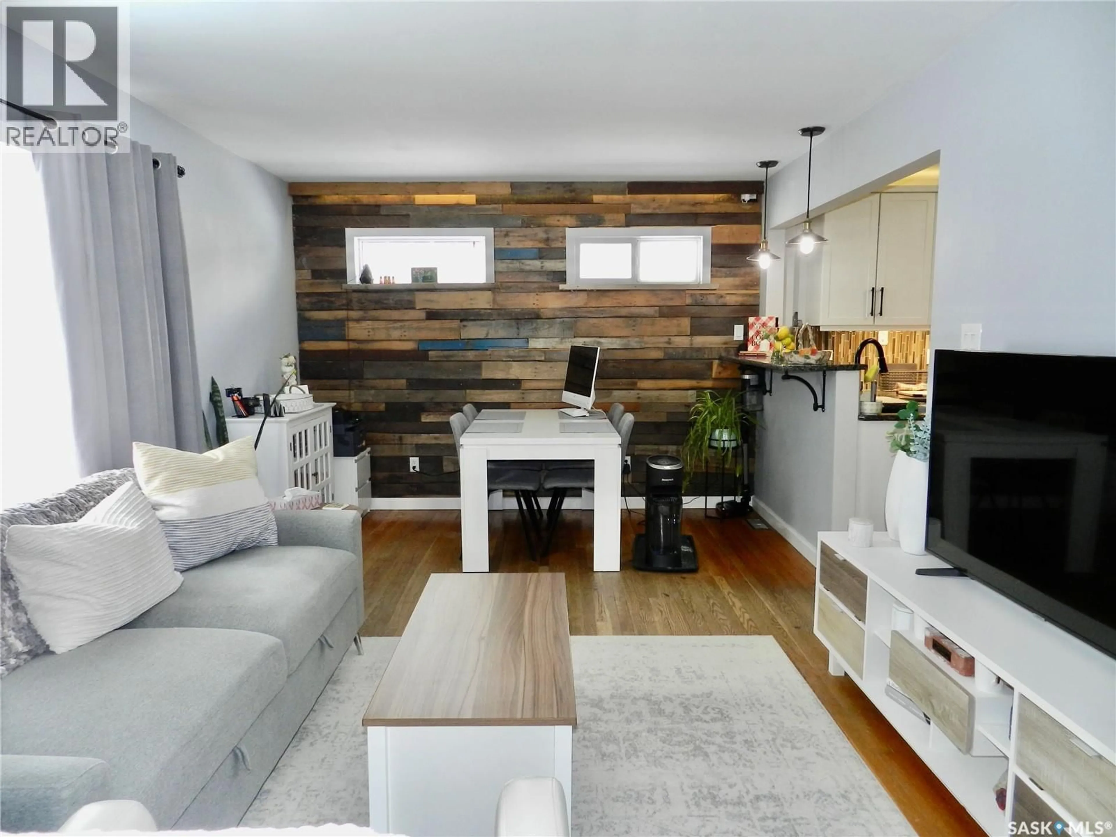 Living room with furniture, wood/laminate floor for 1127 1ST AVENUE, Moose Jaw Saskatchewan S6H3N4