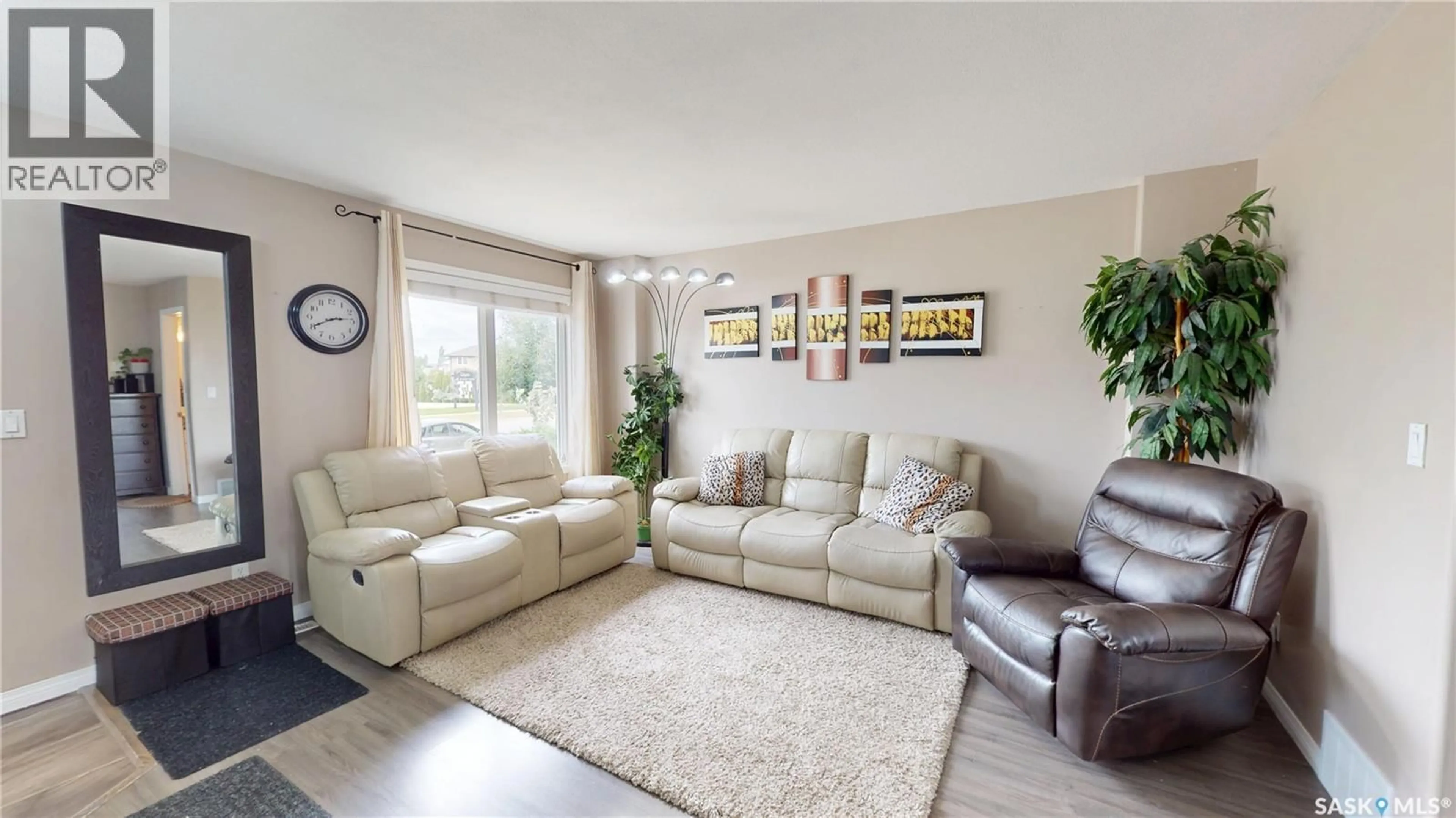Living room with furniture, wood/laminate floor for 2933 MCCLOCKLIN ROAD, Saskatoon Saskatchewan S7R0A1