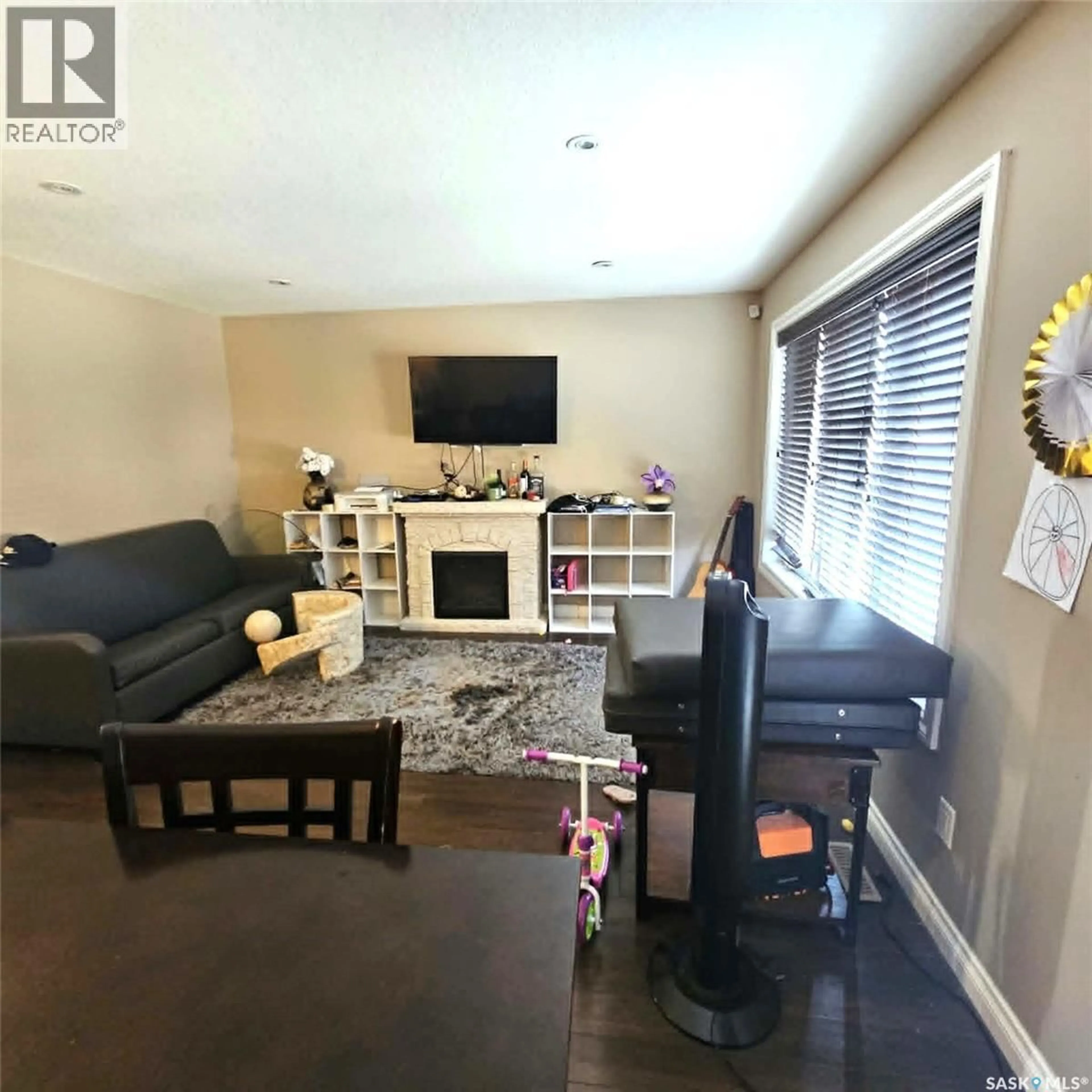 Living room with furniture, wood/laminate floor for 5008 AERIAL CRESCENT, Regina Saskatchewan S4W0C9