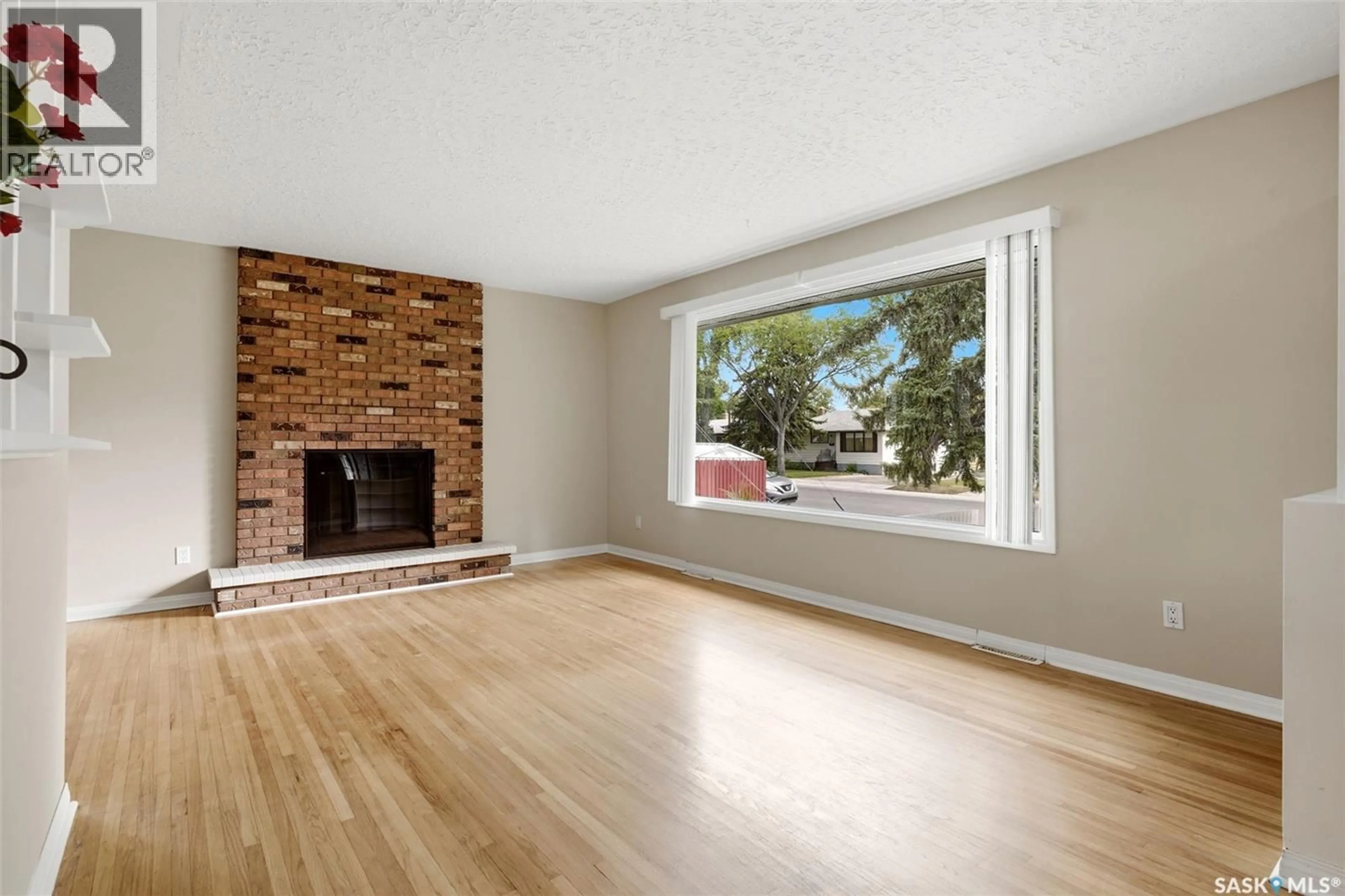 Living room with furniture, wood/laminate floor for 202 MCCANNEL STREET, Regina Saskatchewan S4R3V1