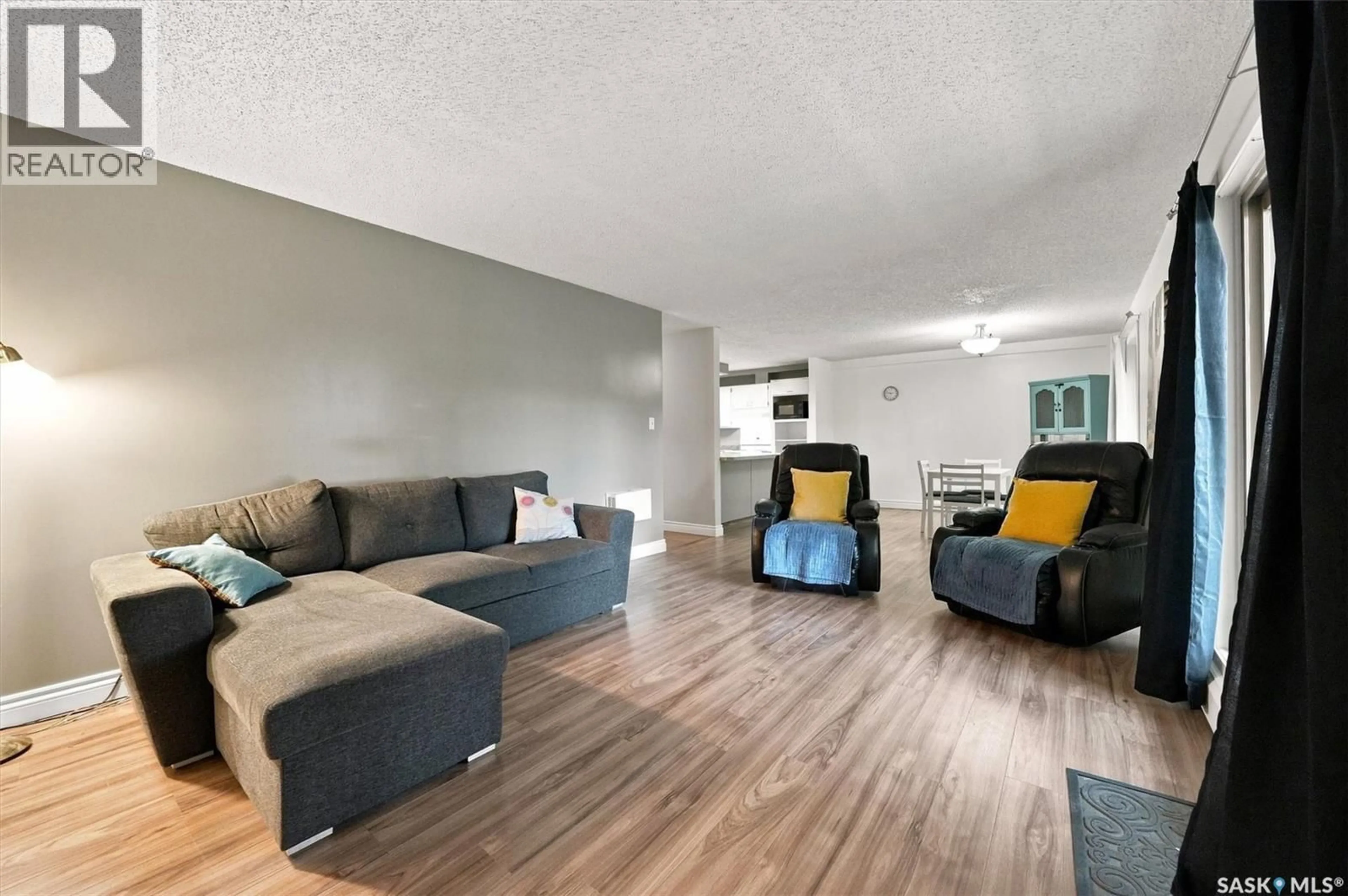 Living room with furniture, wood/laminate floor for 102 - 1008 TEMPERANCE STREET, Saskatoon Saskatchewan S7N0N6
