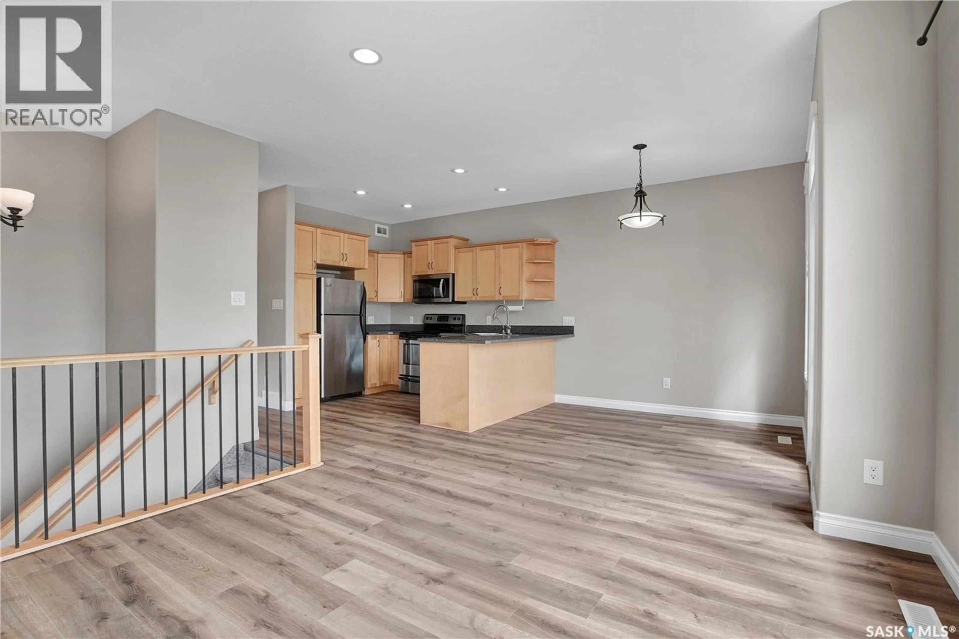 Open concept kitchen, wood/laminate floor for 1 112 HIEBERT CRESCENT, Martensville Saskatchewan S0K2T2