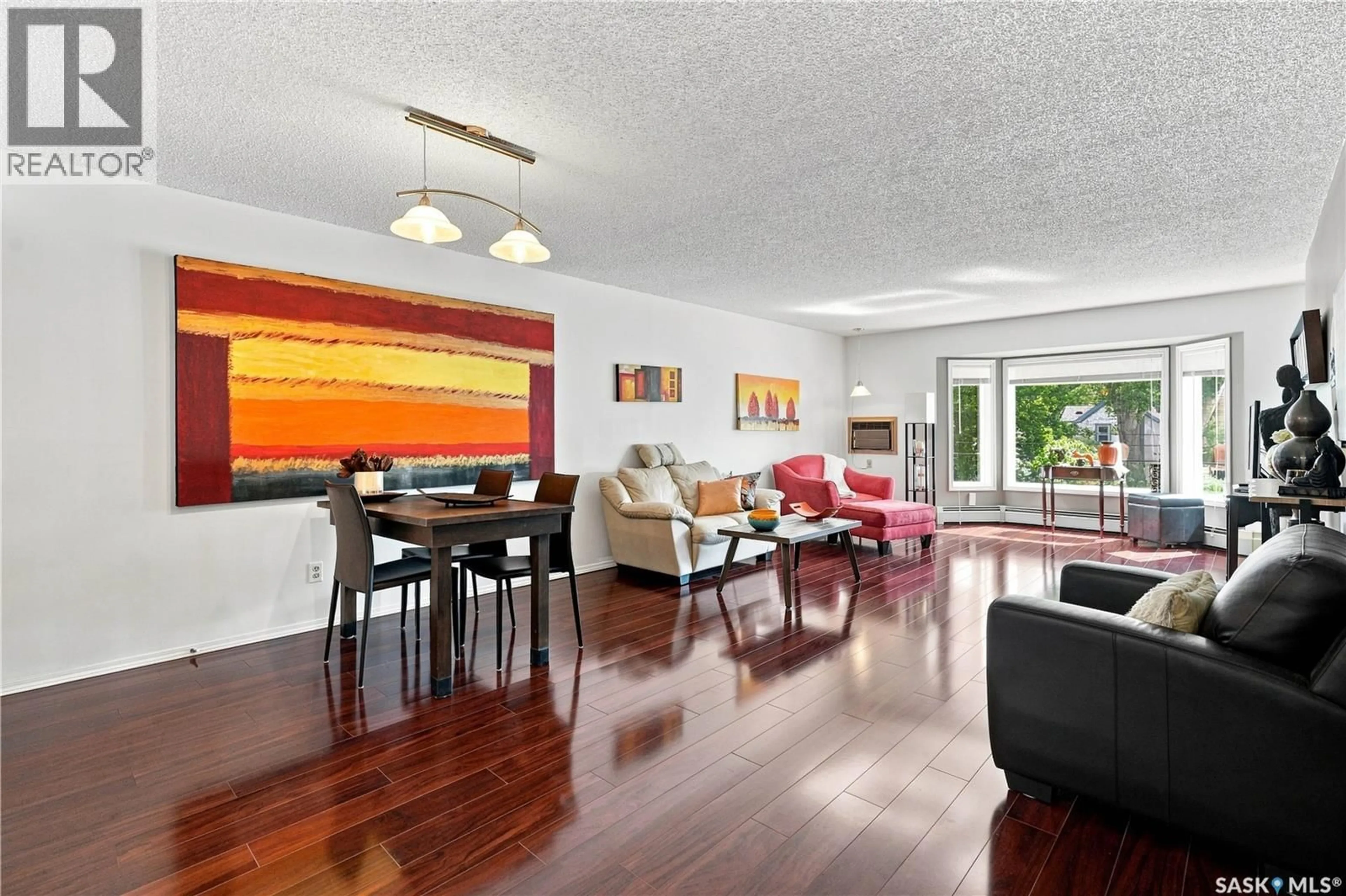 Living room with furniture, wood/laminate floor for 208 - 410 MAIN STREET, Saskatoon Saskatchewan S7N0B8