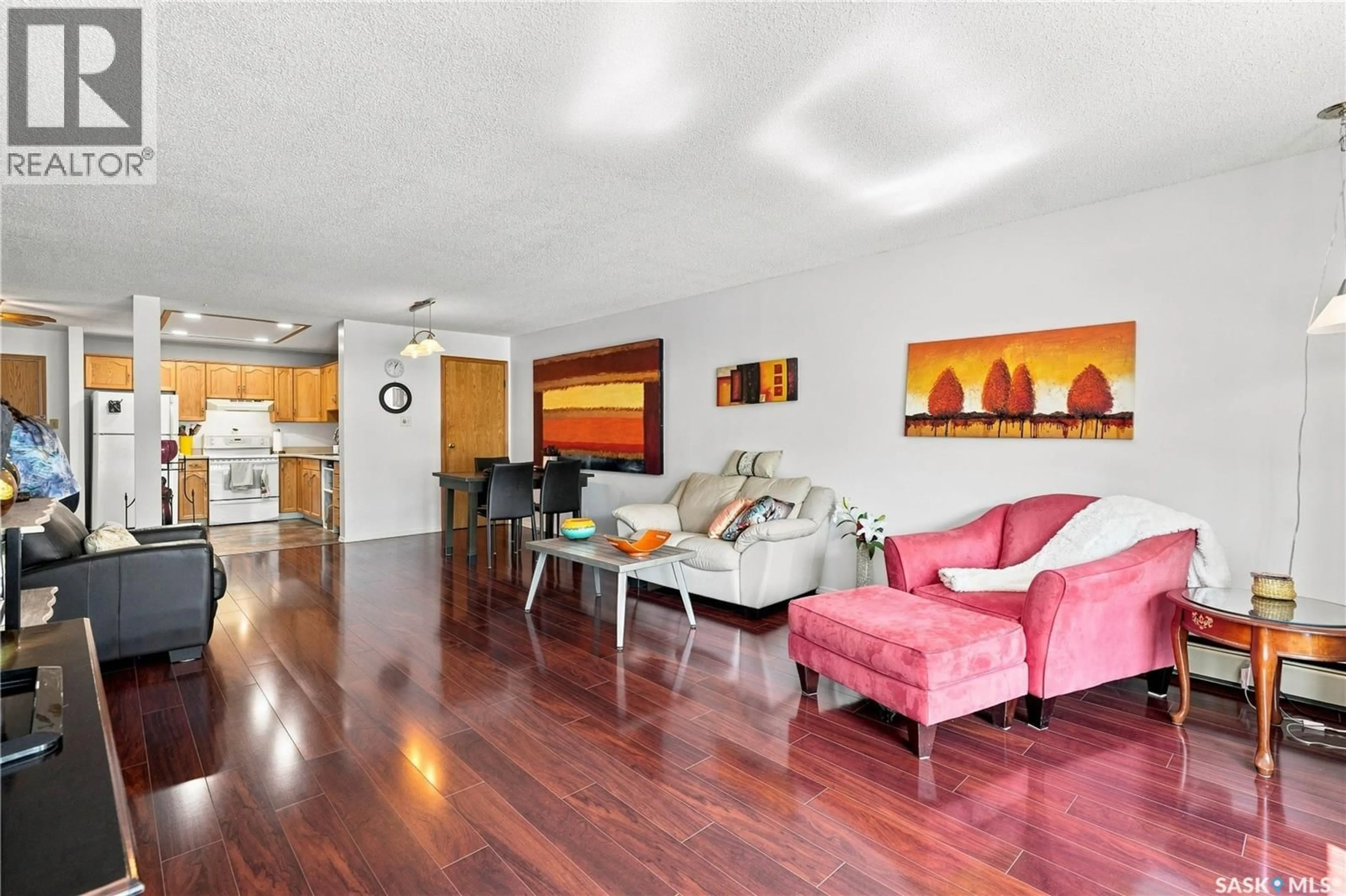 Living room with furniture, wood/laminate floor for 208 - 410 MAIN STREET, Saskatoon Saskatchewan S7N0B8