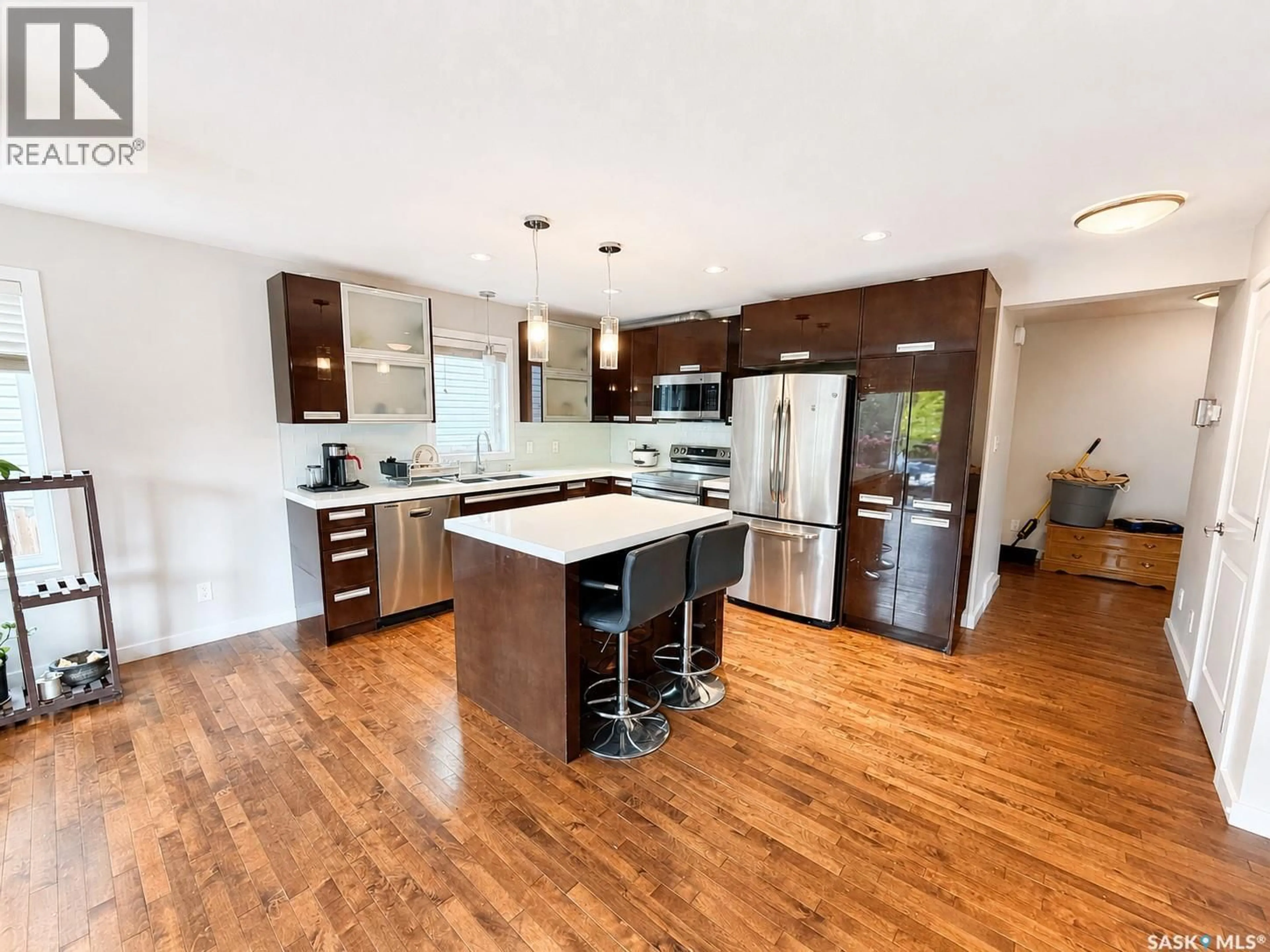 Open concept kitchen, wood/laminate floor for 110 CHUBB COVE, Saskatoon Saskatchewan S7T0E6