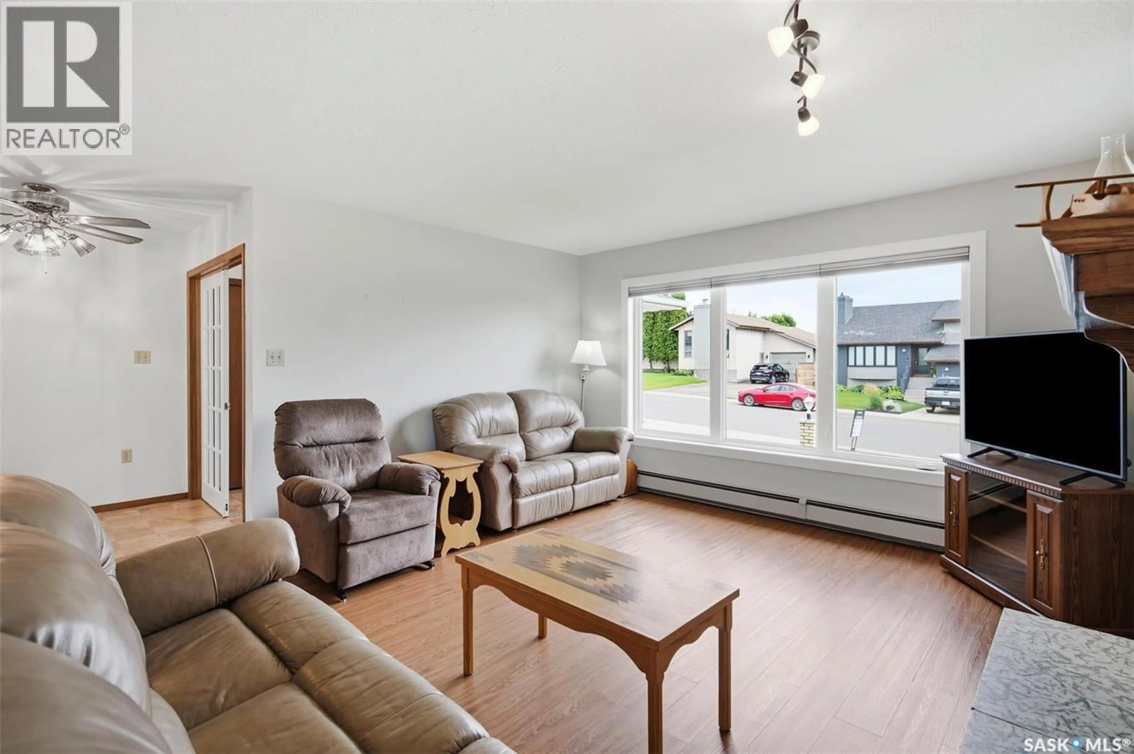 Living room with furniture, wood/laminate floor for 139 WRIGHT CRESCENT, Biggar Saskatchewan S0K0M0