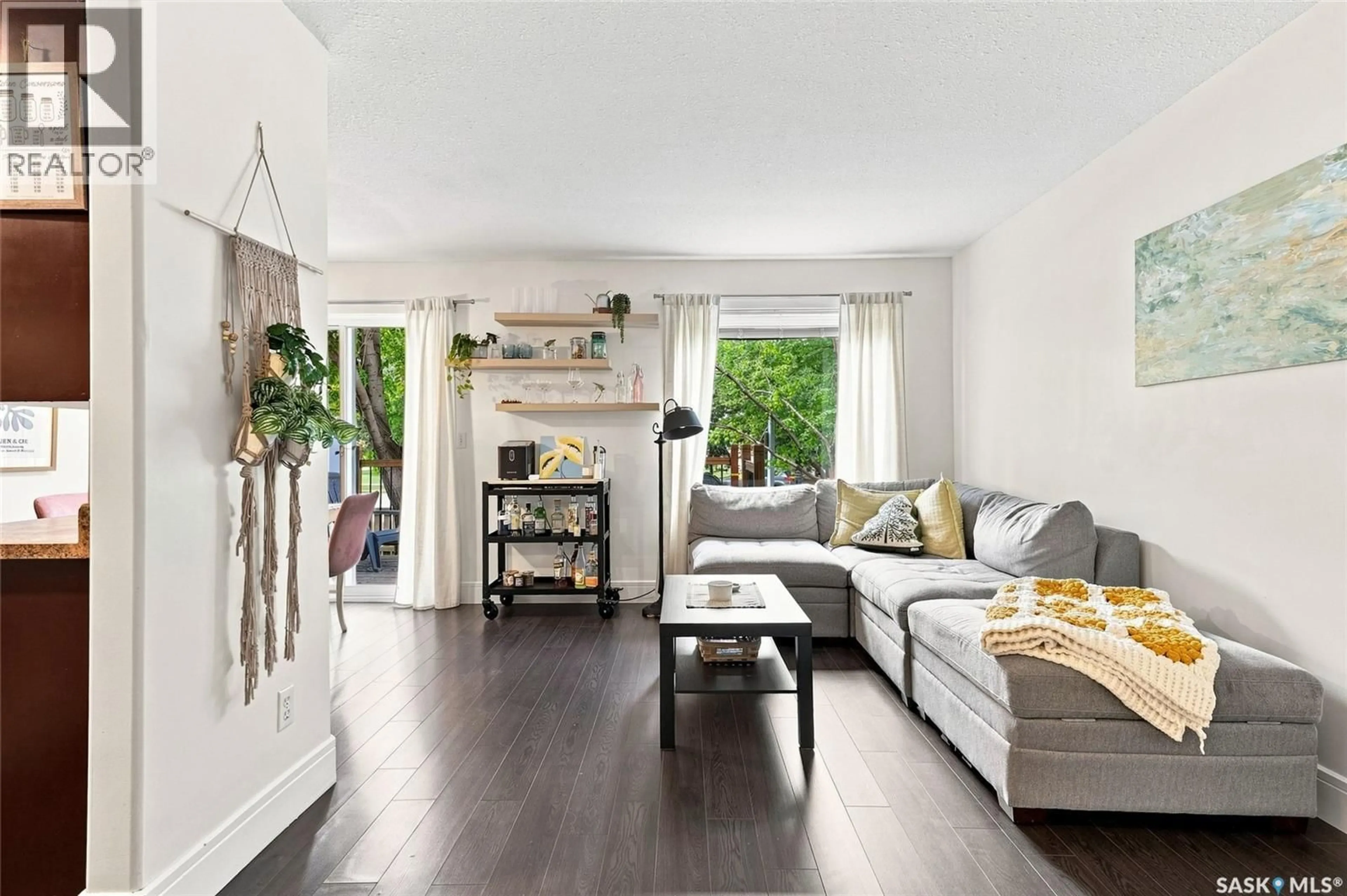 Living room with furniture, wood/laminate floor for 20 327 BERINI DRIVE, Saskatoon Saskatchewan S7N4M7