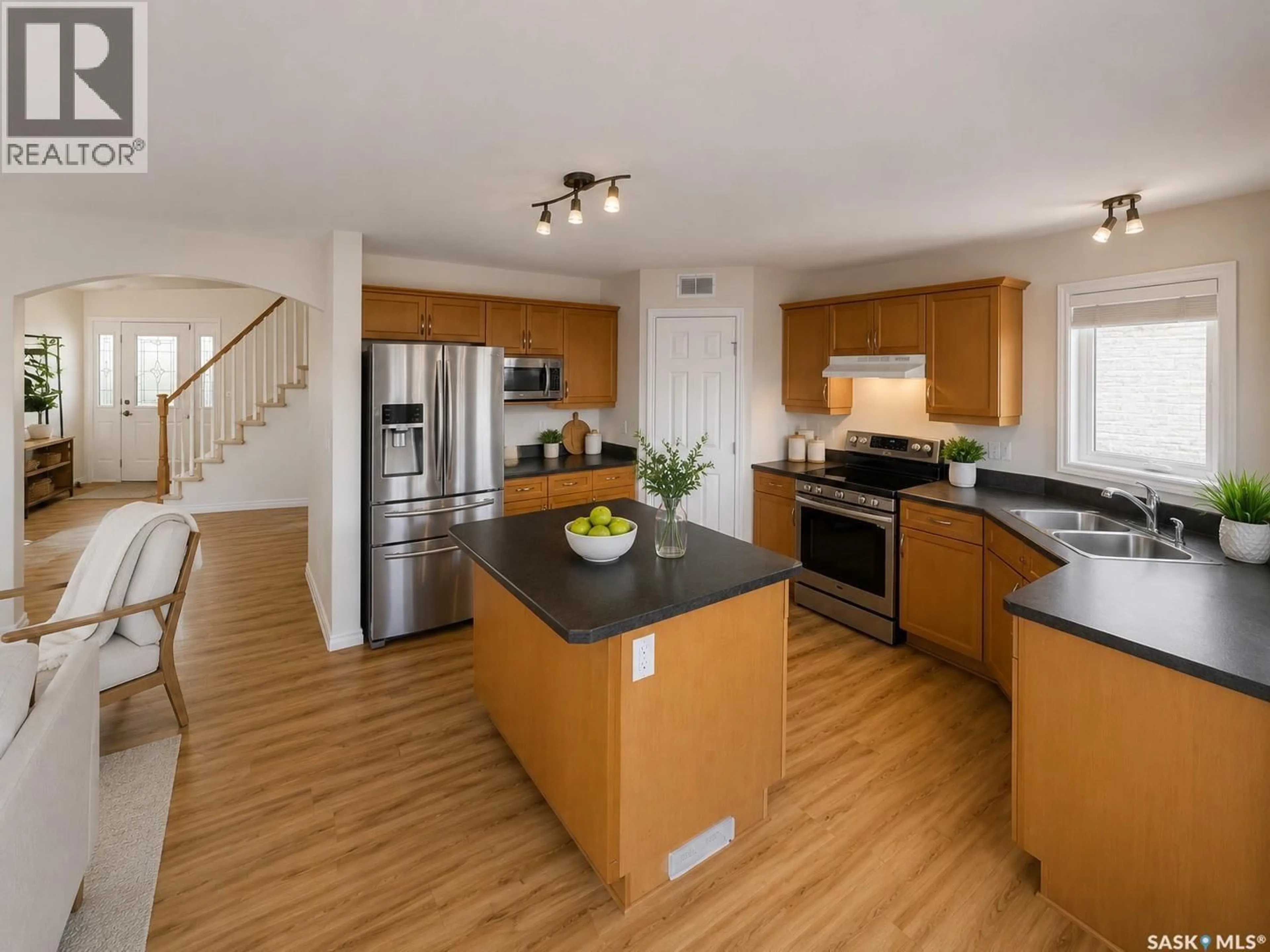 Open concept kitchen, wood/laminate floor for 330 BLACKSTOCK COVE, Saskatoon Saskatchewan S7T0H3