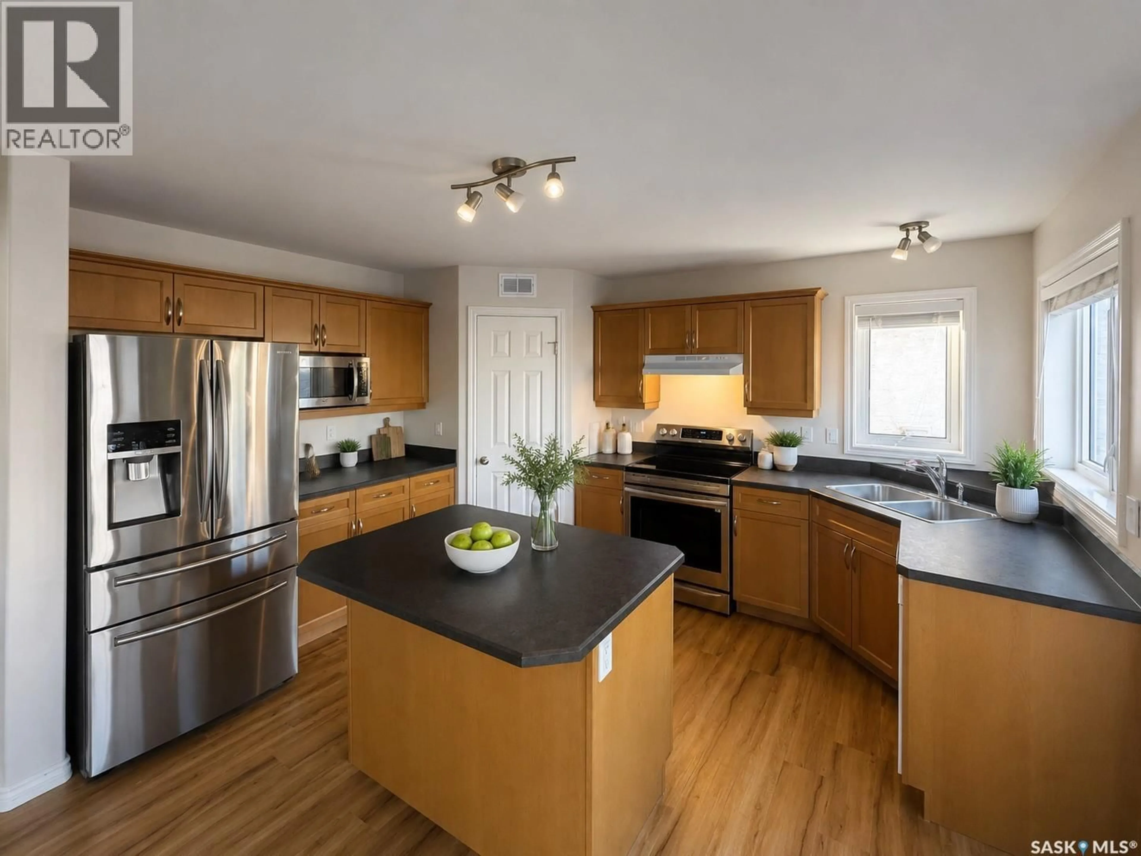 Open concept kitchen, wood/laminate floor for 330 BLACKSTOCK COVE, Saskatoon Saskatchewan S7T0H3