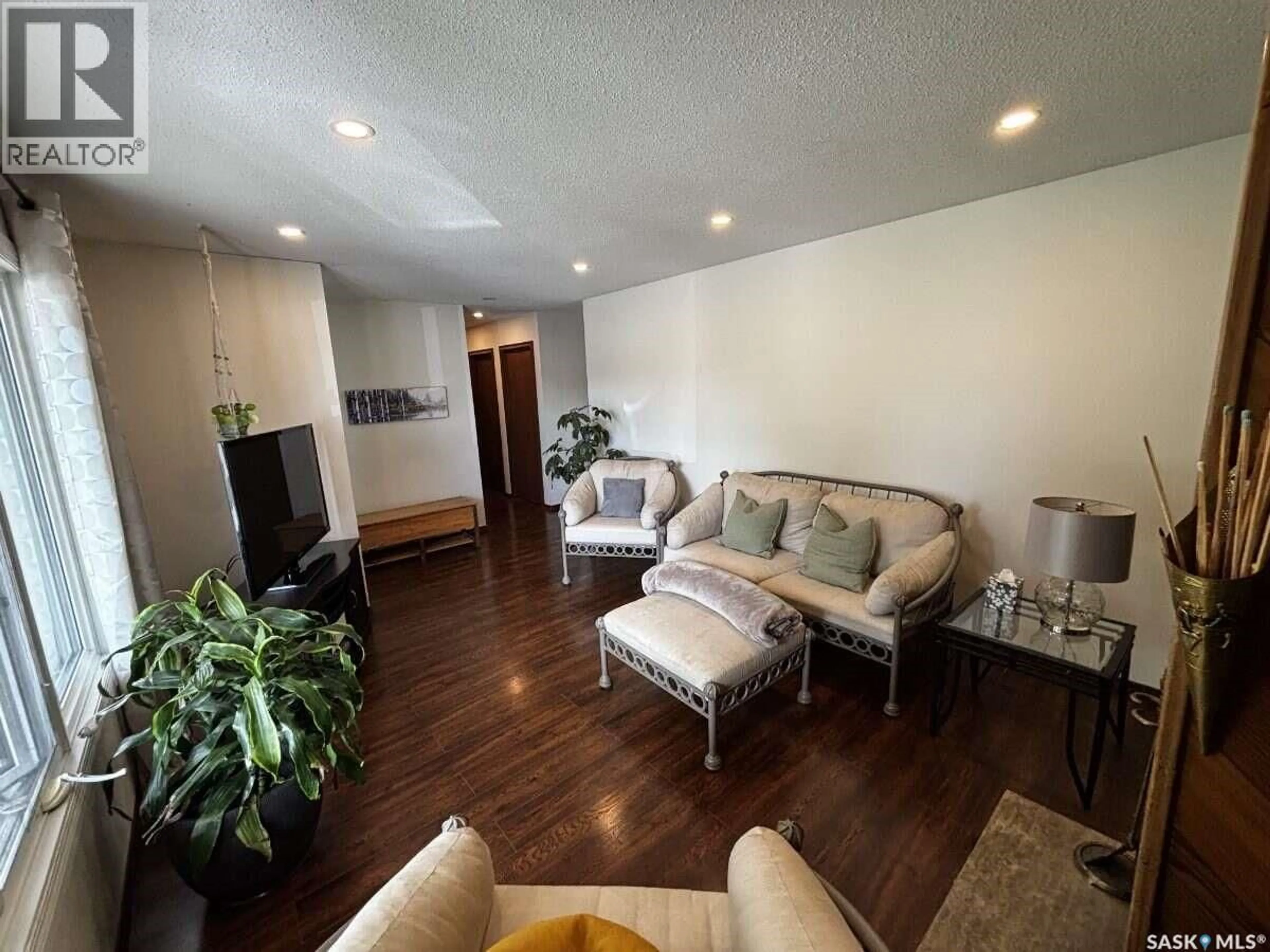 Living room with furniture, wood/laminate floor for 195 WELLS STREET, Regina Saskatchewan S4R5Z6
