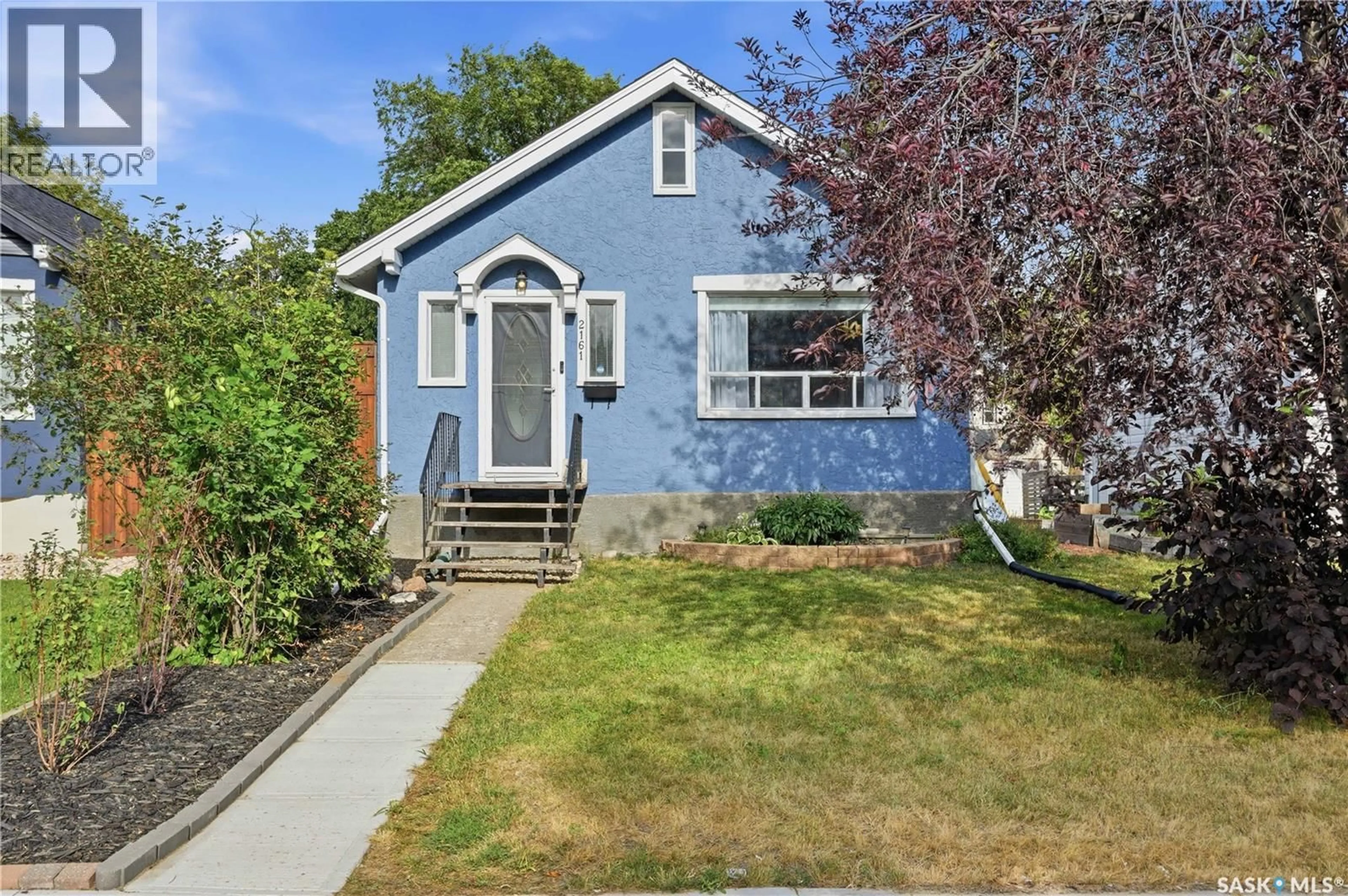 Home with vinyl exterior material, street for 2161 QUEEN STREET, Regina Saskatchewan S4T4C4
