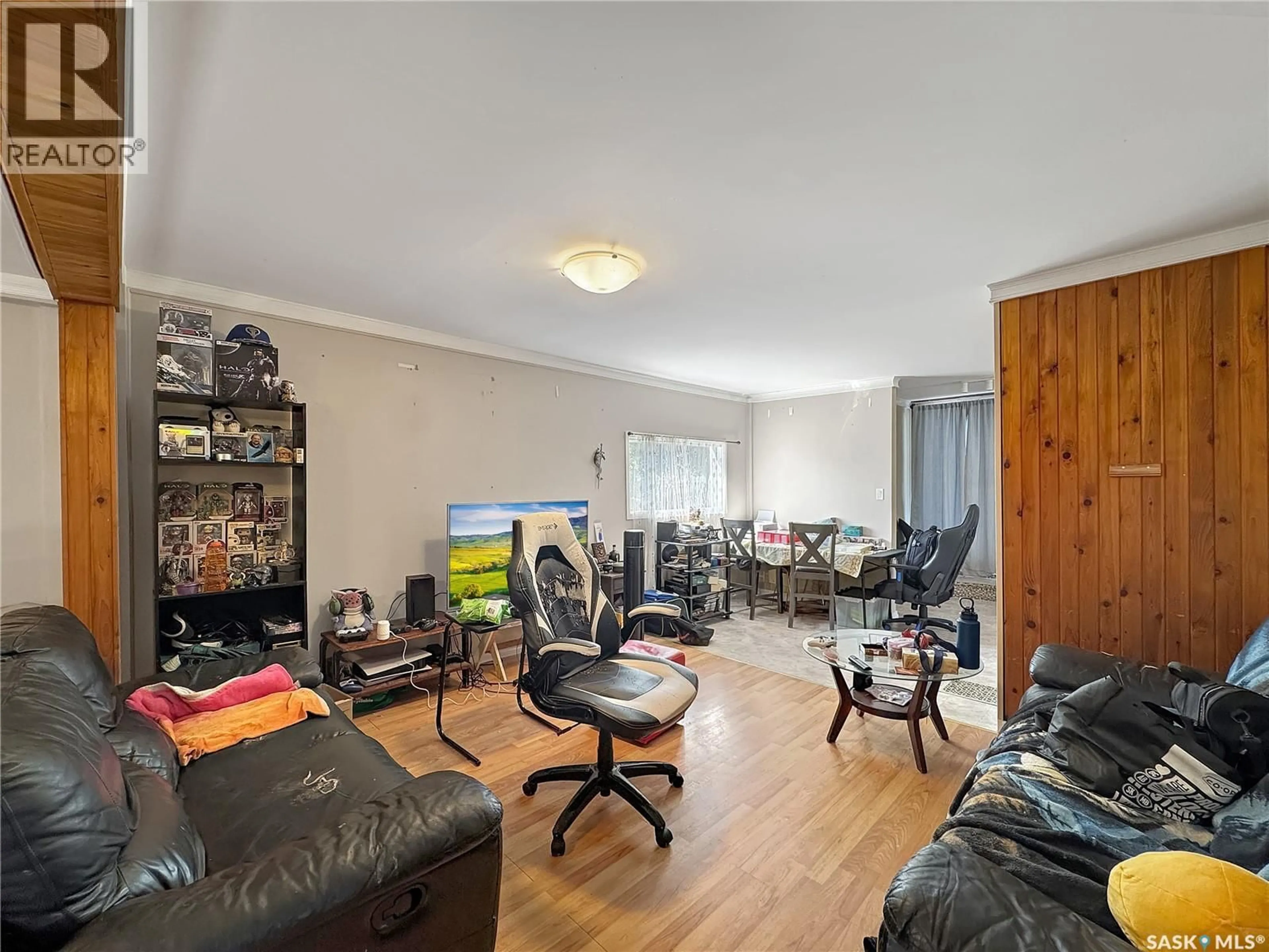 Living room with furniture, wood/laminate floor for 1671 103RD STREET, North Battleford Saskatchewan S9A1L6