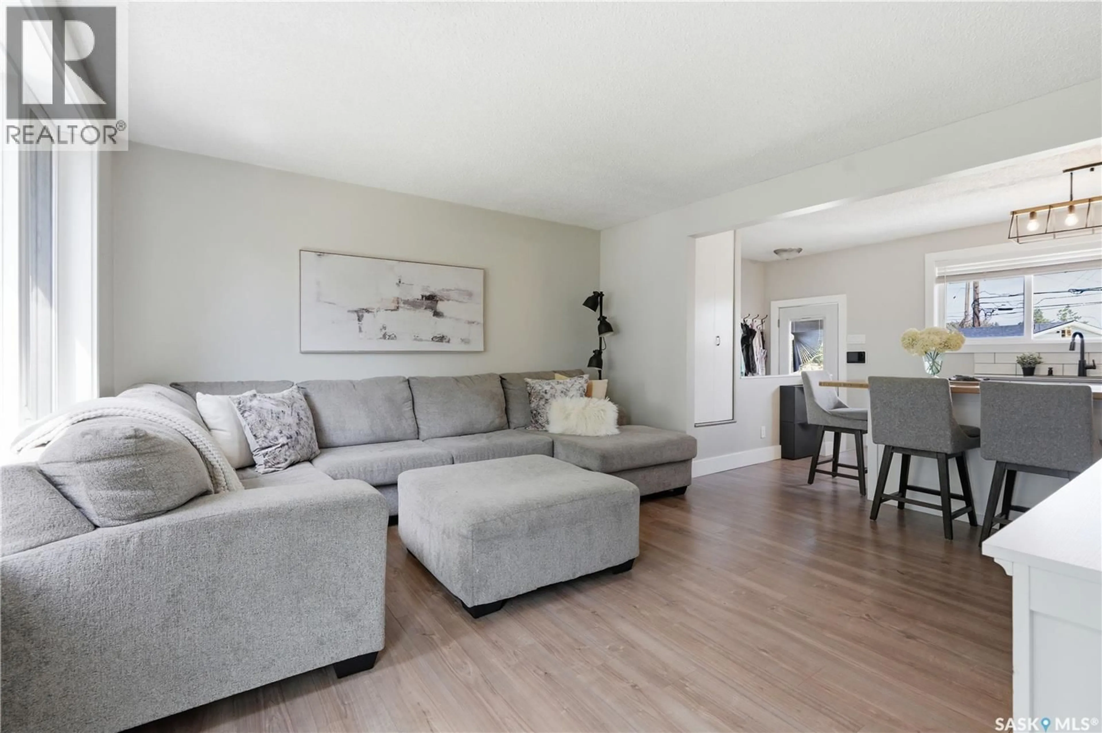 Living room with furniture, wood/laminate floor for 122 MONTREAL AVENUE, Saskatoon Saskatchewan S7M3K8