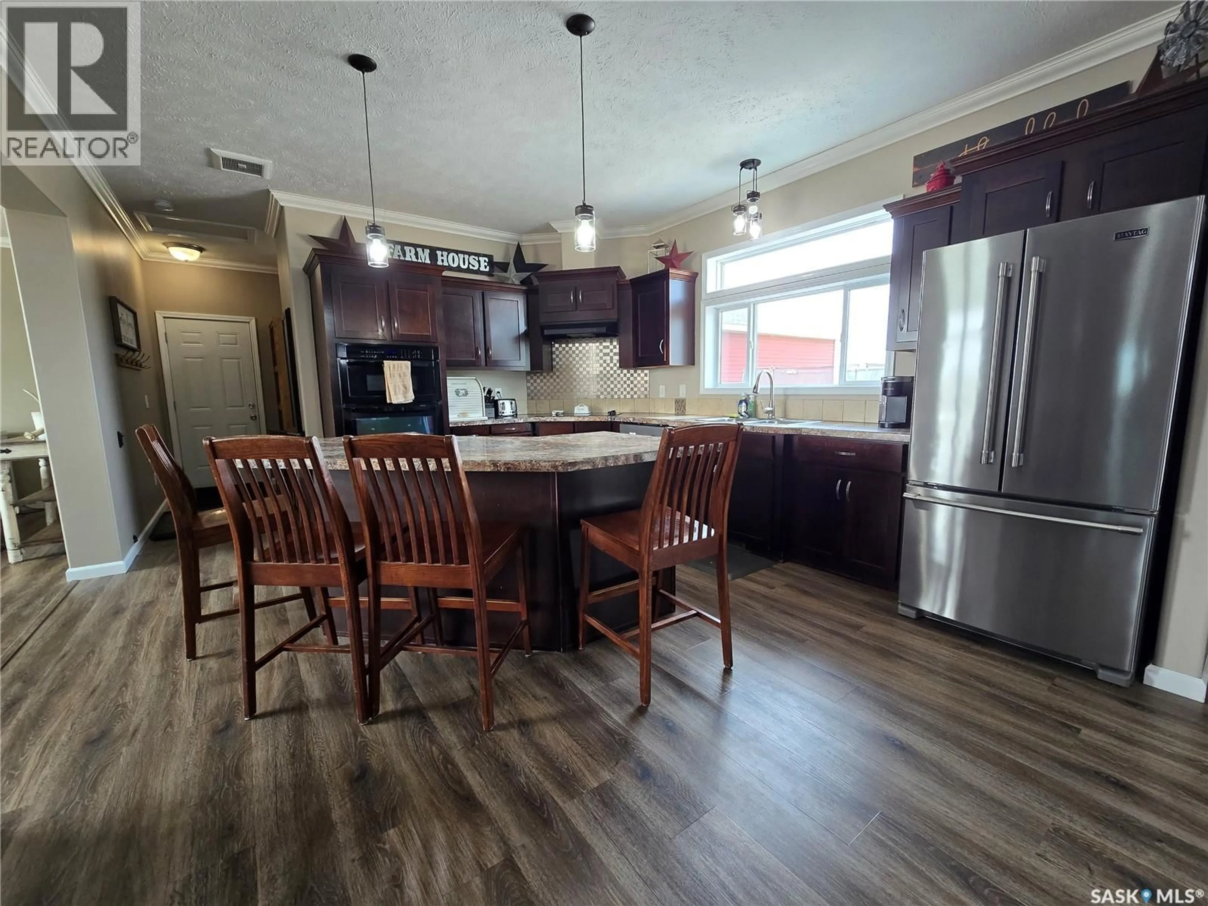 Open concept kitchen, wood/laminate floor for EBERTS ACREAGE, Weyburn Rm No. 67 Saskatchewan S4H2J9