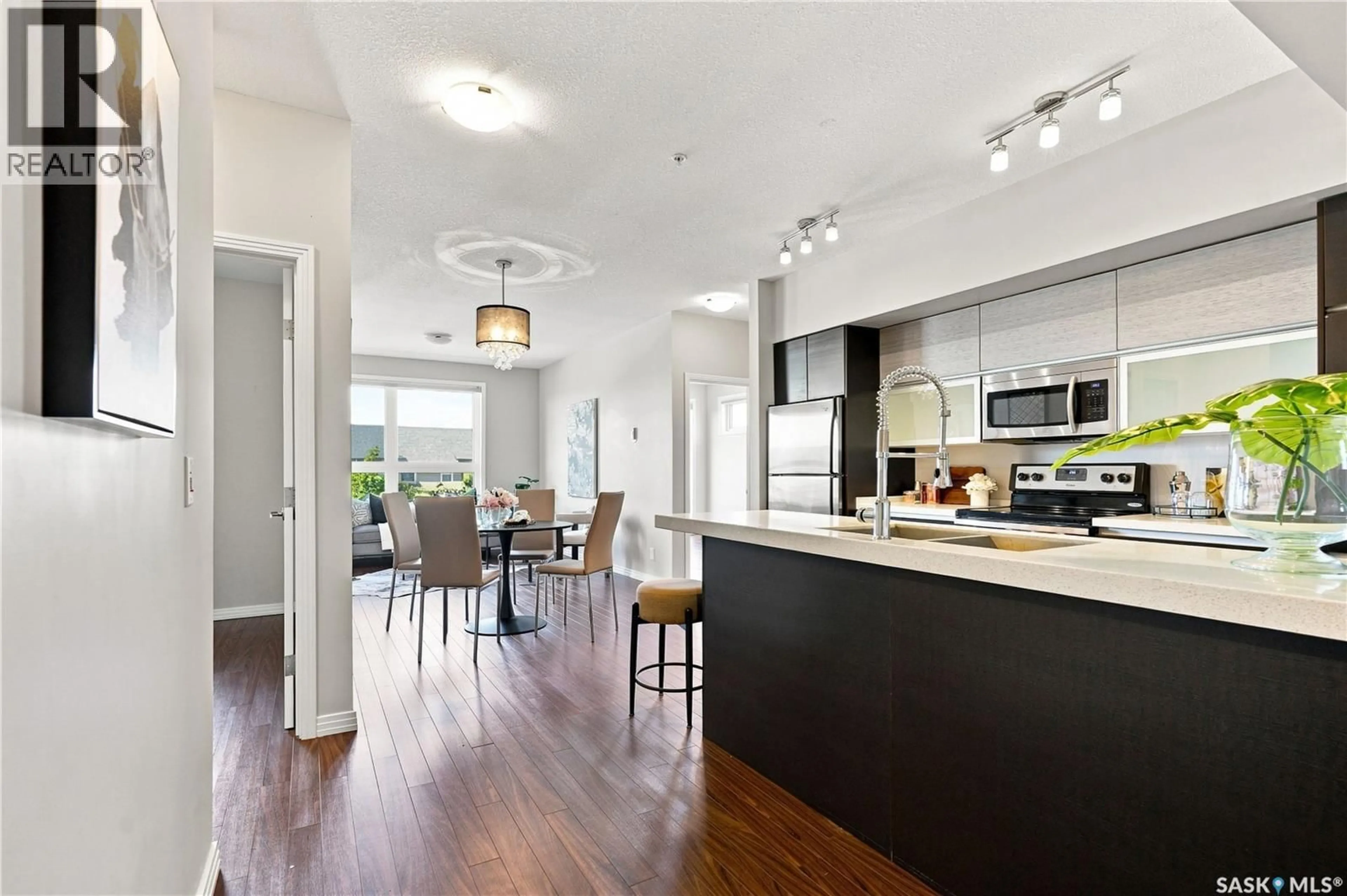 Open concept kitchen, wood/laminate floor for 225 - 206 MANINGAS BEND, Saskatoon Saskatchewan S7W0P9