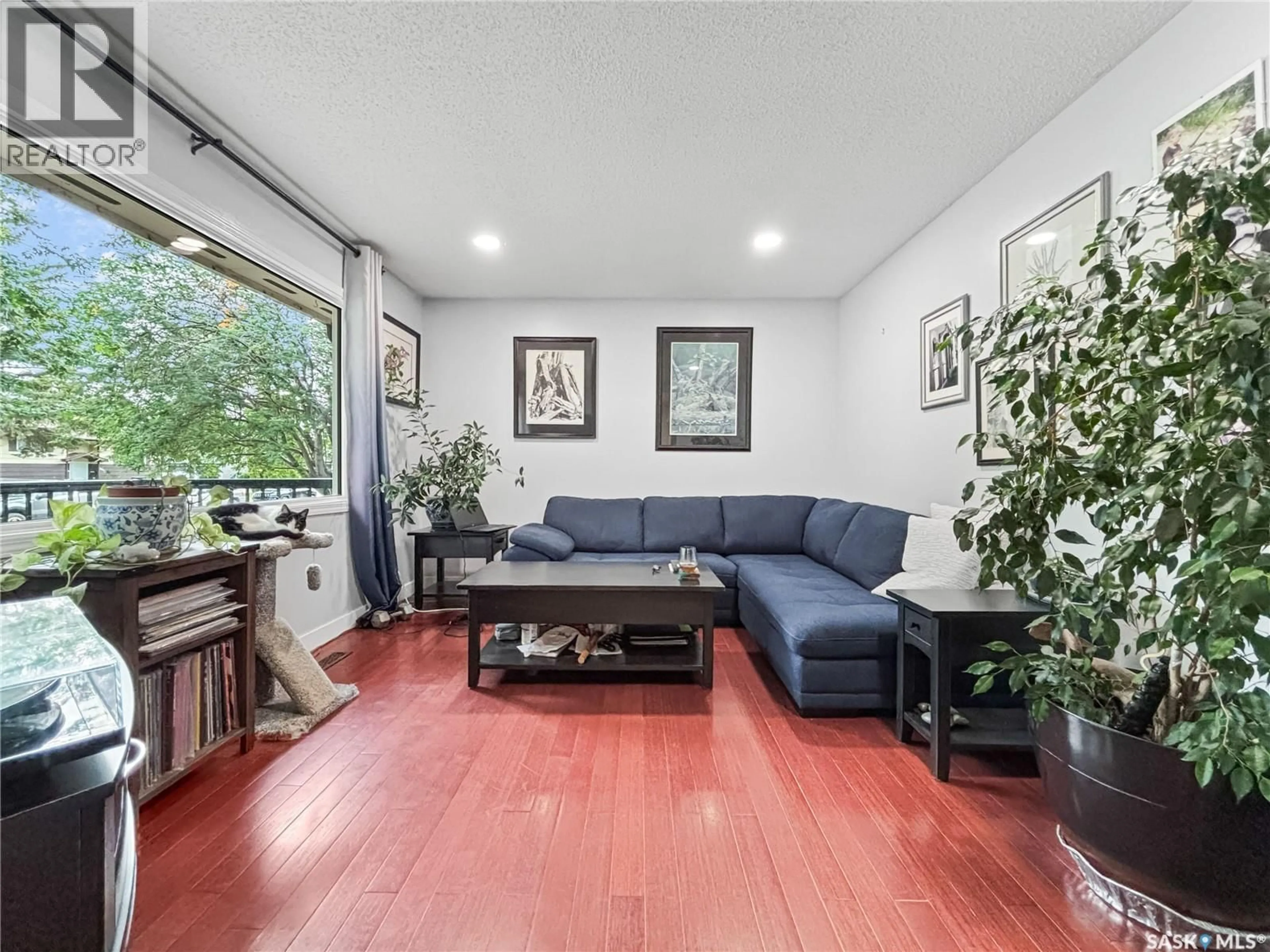 Living room with furniture, wood/laminate floor for 330 MEIGHEN CRESCENT, Saskatoon Saskatchewan S7L4W7