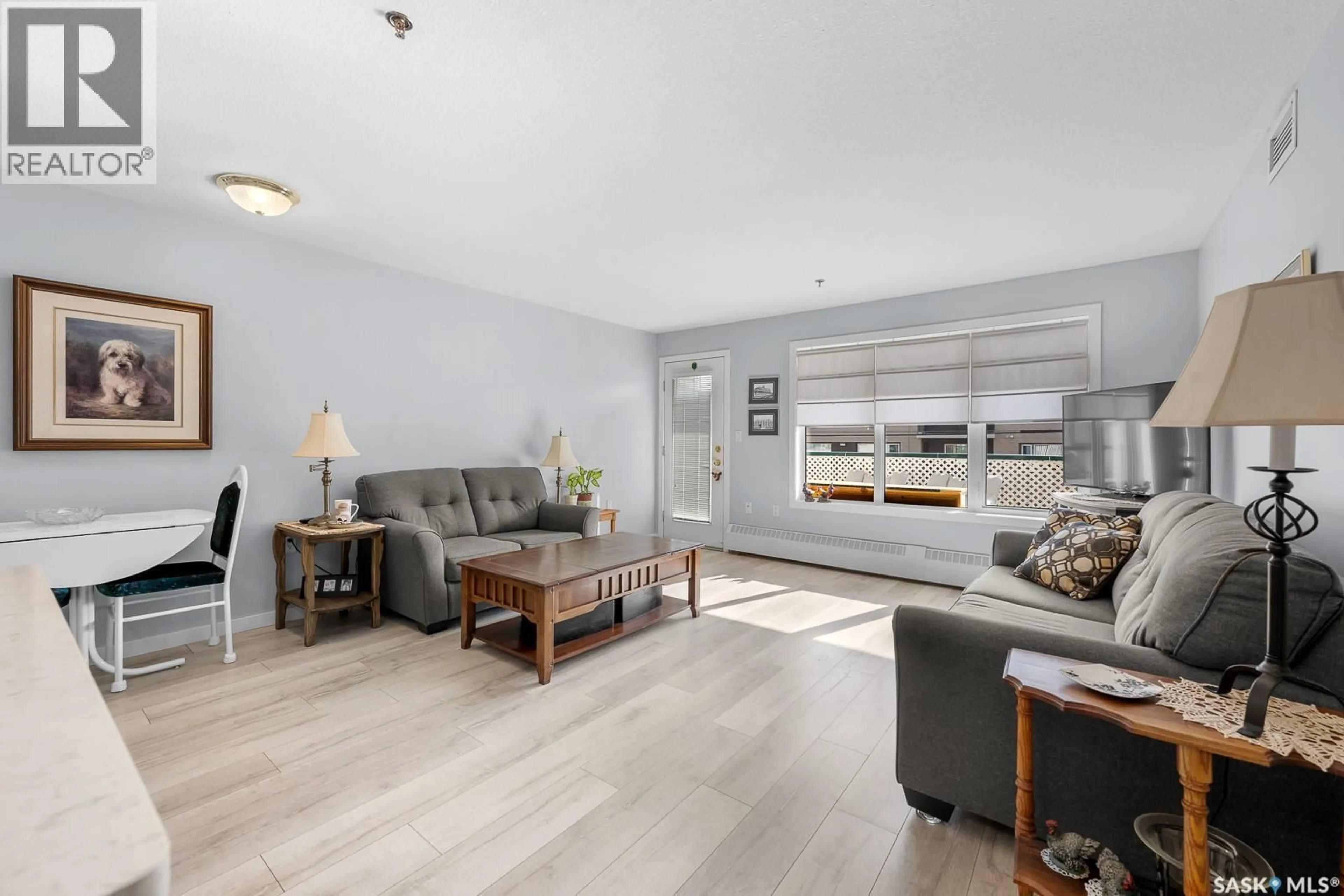 Living room with furniture, wood/laminate floor for 207 MCINTYRE STREET, Regina Saskatchewan S4R3B7