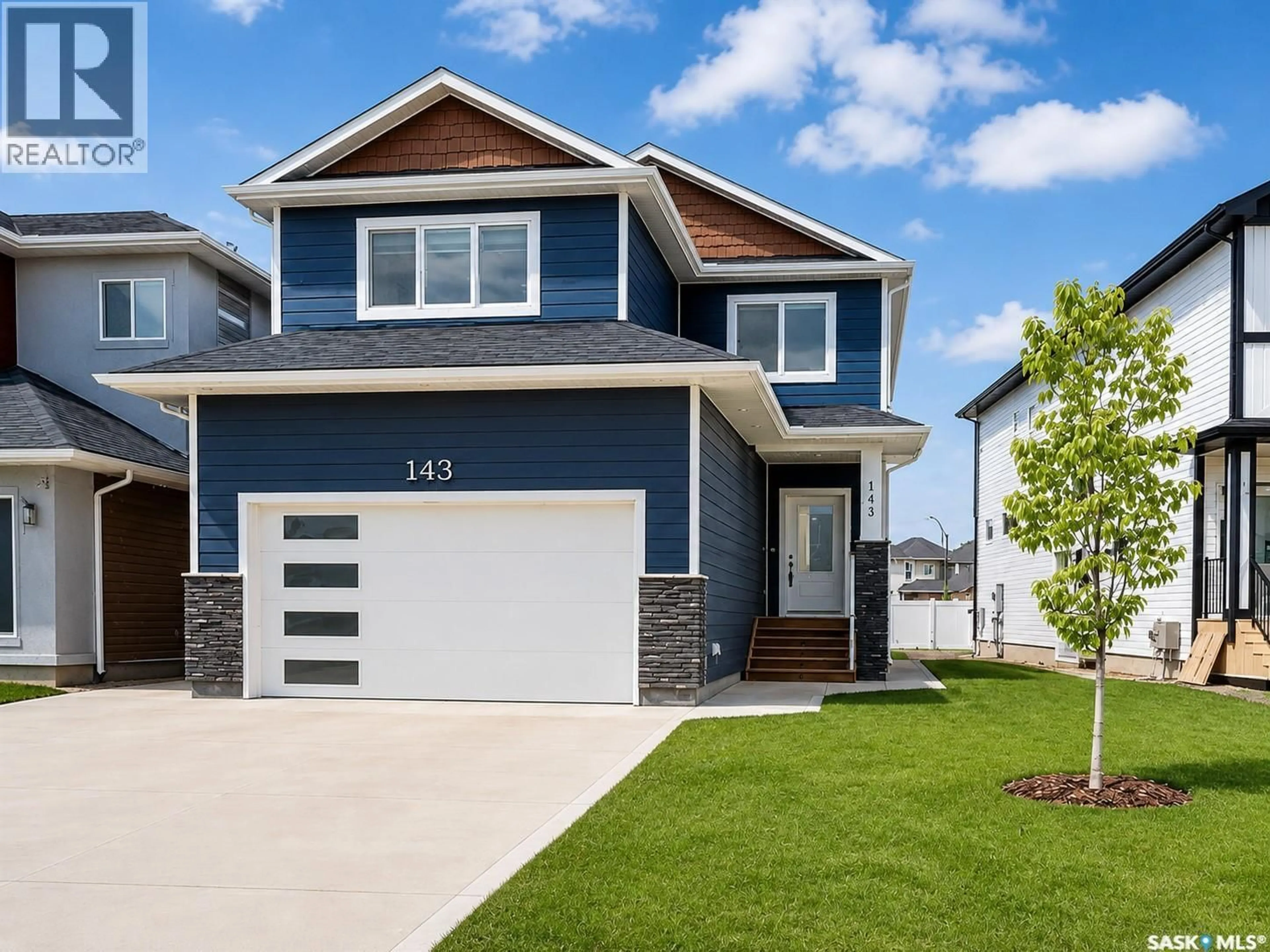Home with vinyl exterior material, street for 143 SHARMA LANE, Saskatoon Saskatchewan S7W1L1