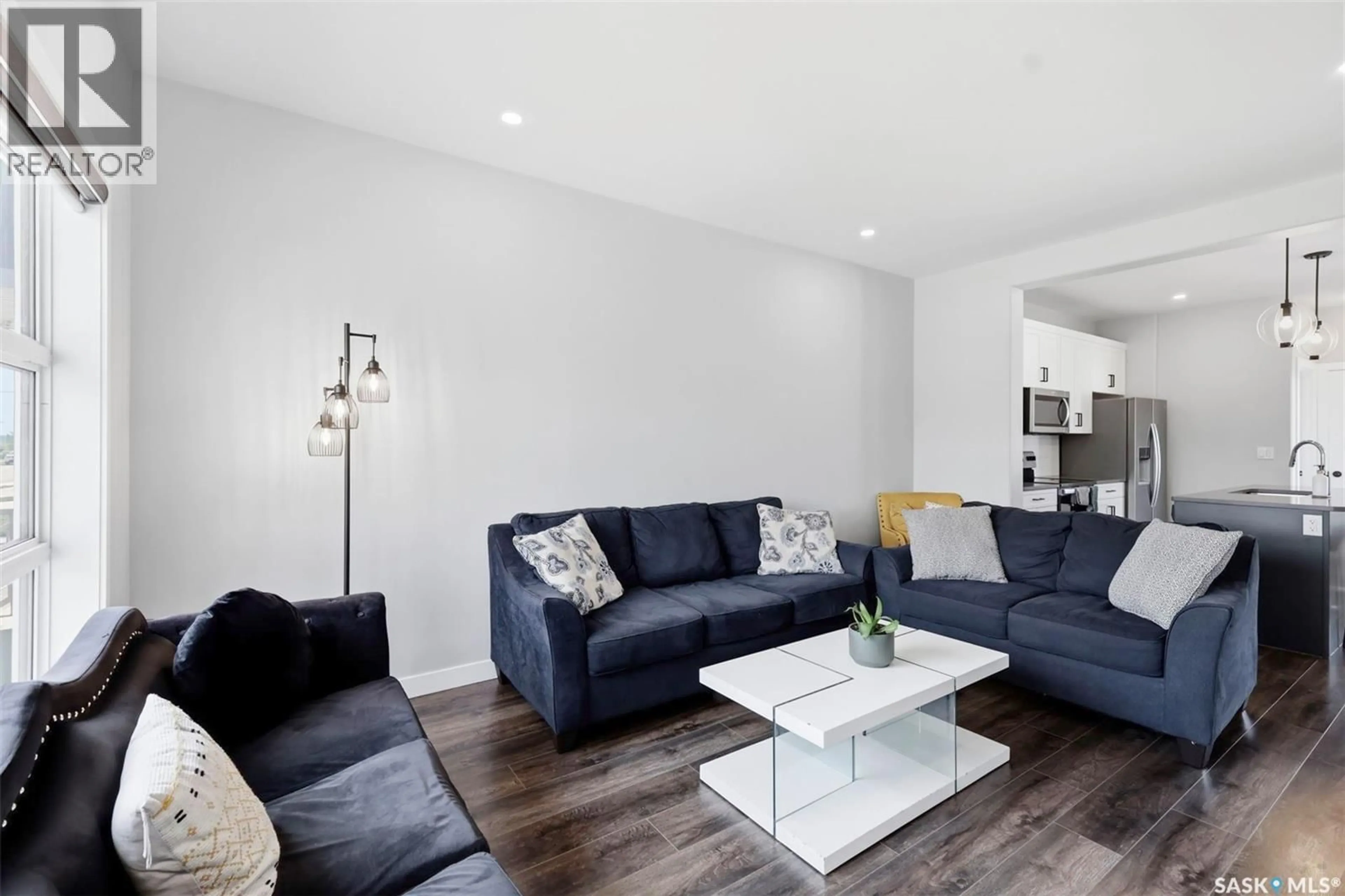 Living room with furniture, wood/laminate floor for 605 FEHEREGYHAZI BOULEVARD, Saskatoon Saskatchewan S7W0Z4