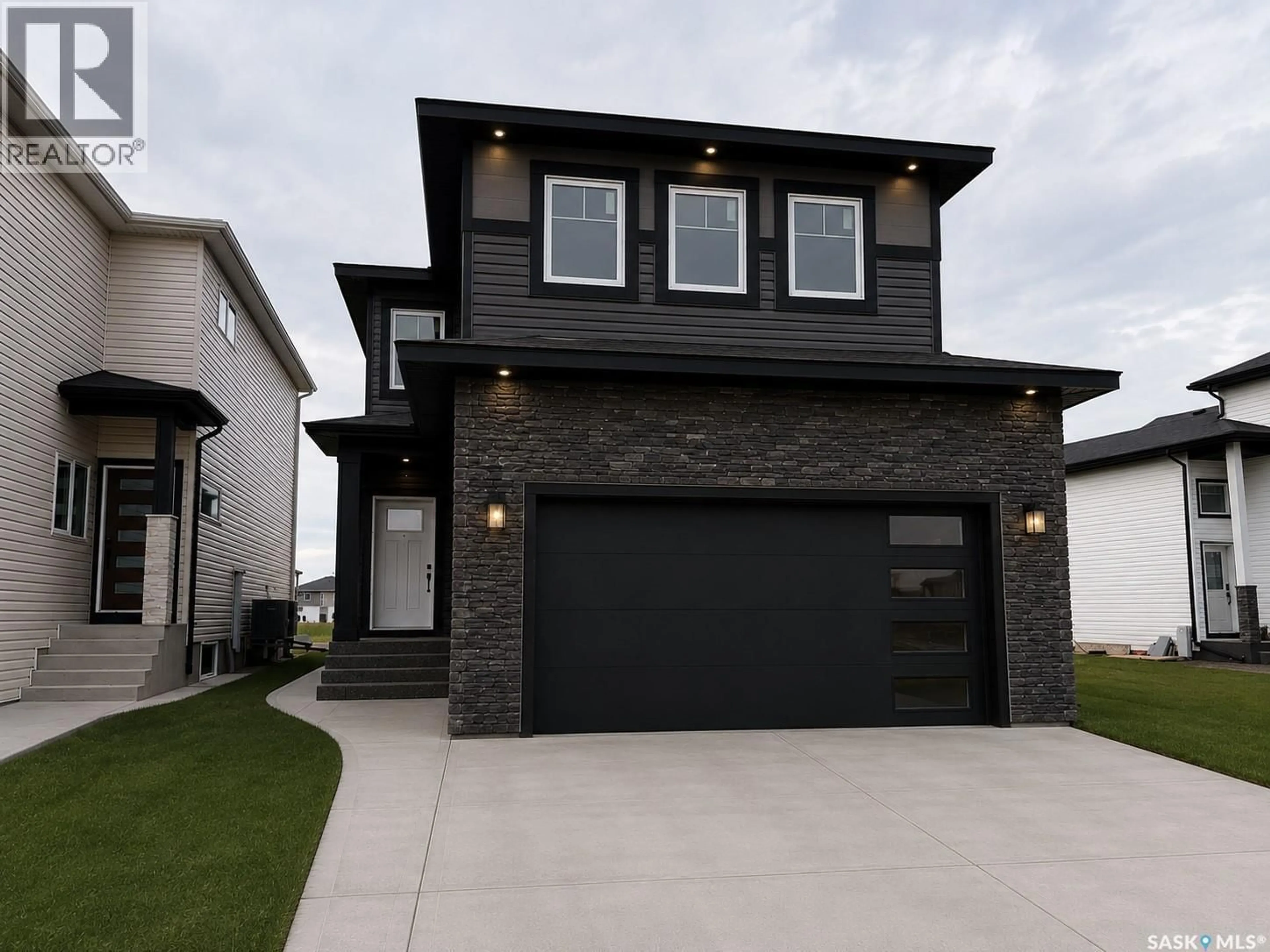 Home with brick exterior material, street for 310 NAZARALI AVENUE, Saskatoon Saskatchewan S7V1N6