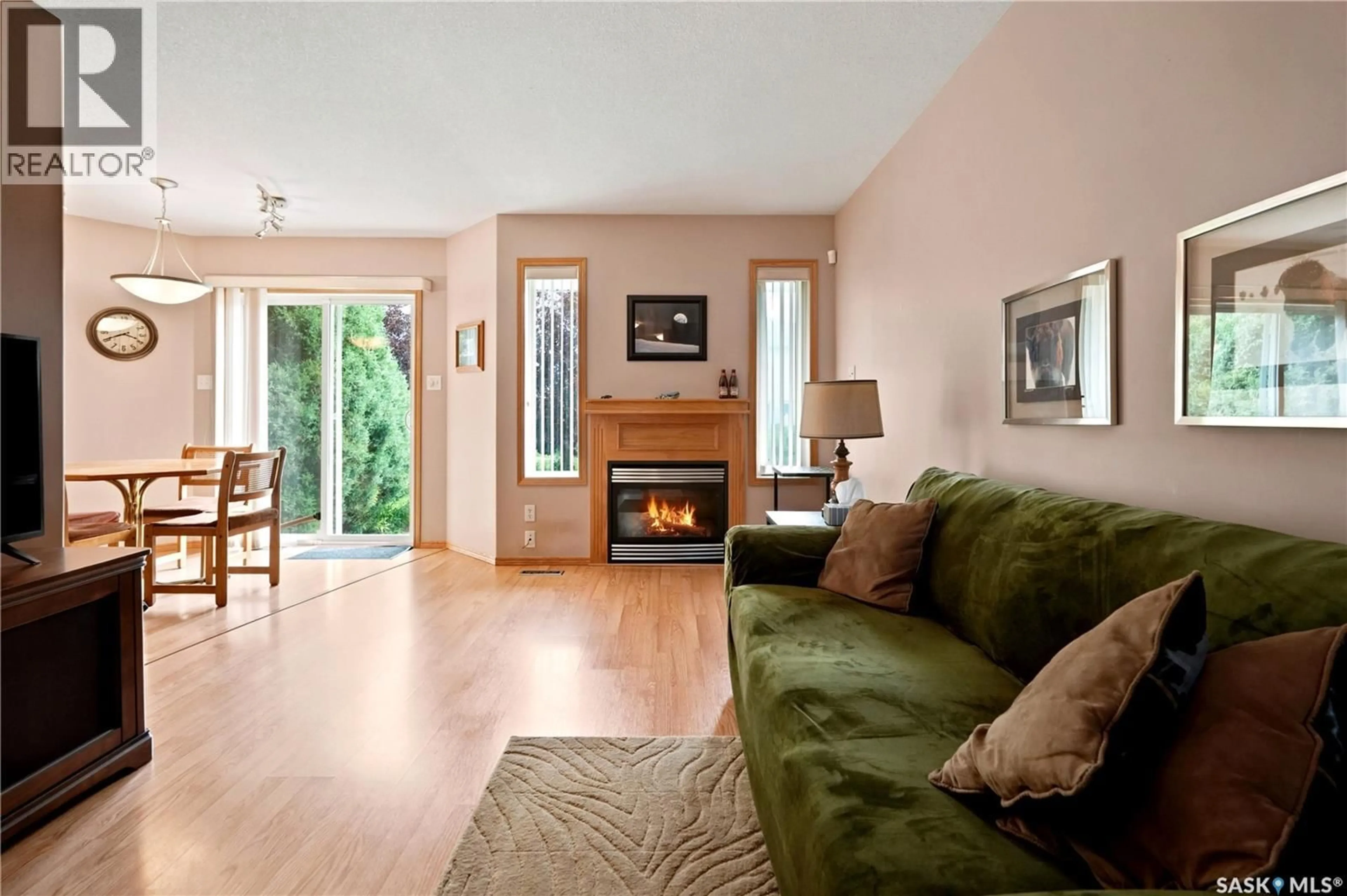 Living room with furniture, wood/laminate floor for 225 MIKKELSON DRIVE, Regina Saskatchewan S4T7X9