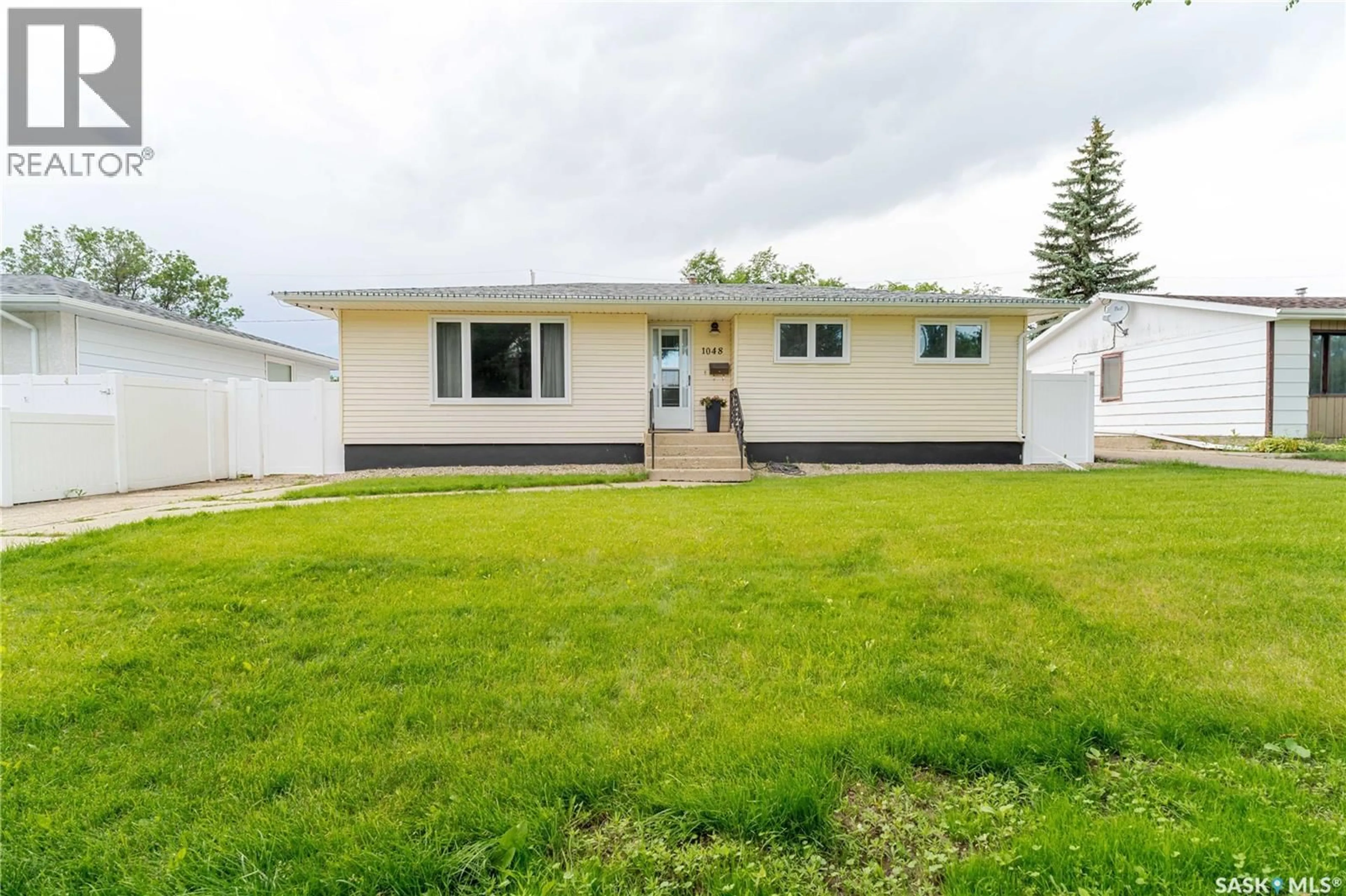 Home with vinyl exterior material, street for 1048 11TH AVENUE, Moose Jaw Saskatchewan S6H4L5