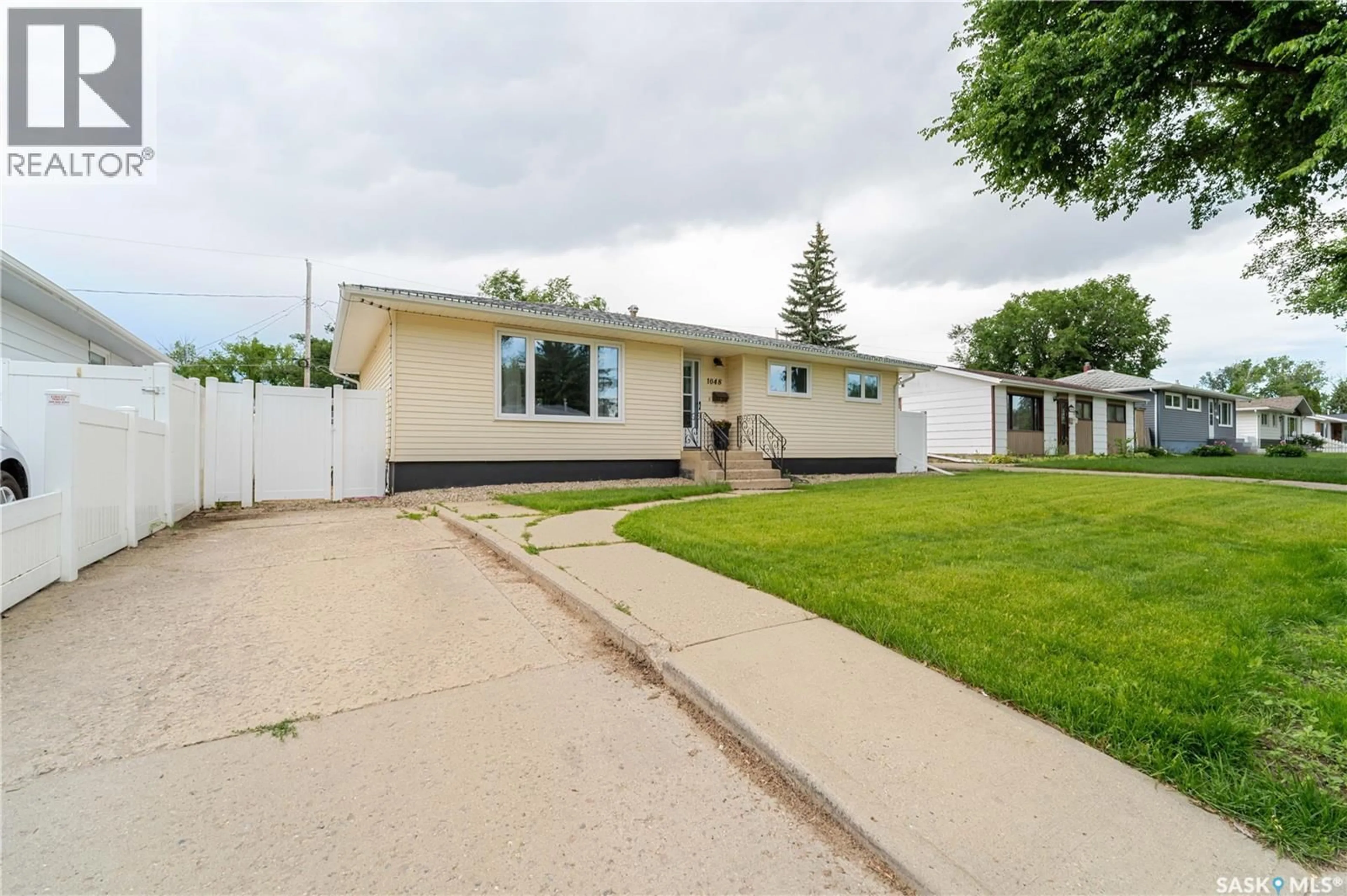 Home with vinyl exterior material, street for 1048 11TH AVENUE, Moose Jaw Saskatchewan S6H4L5