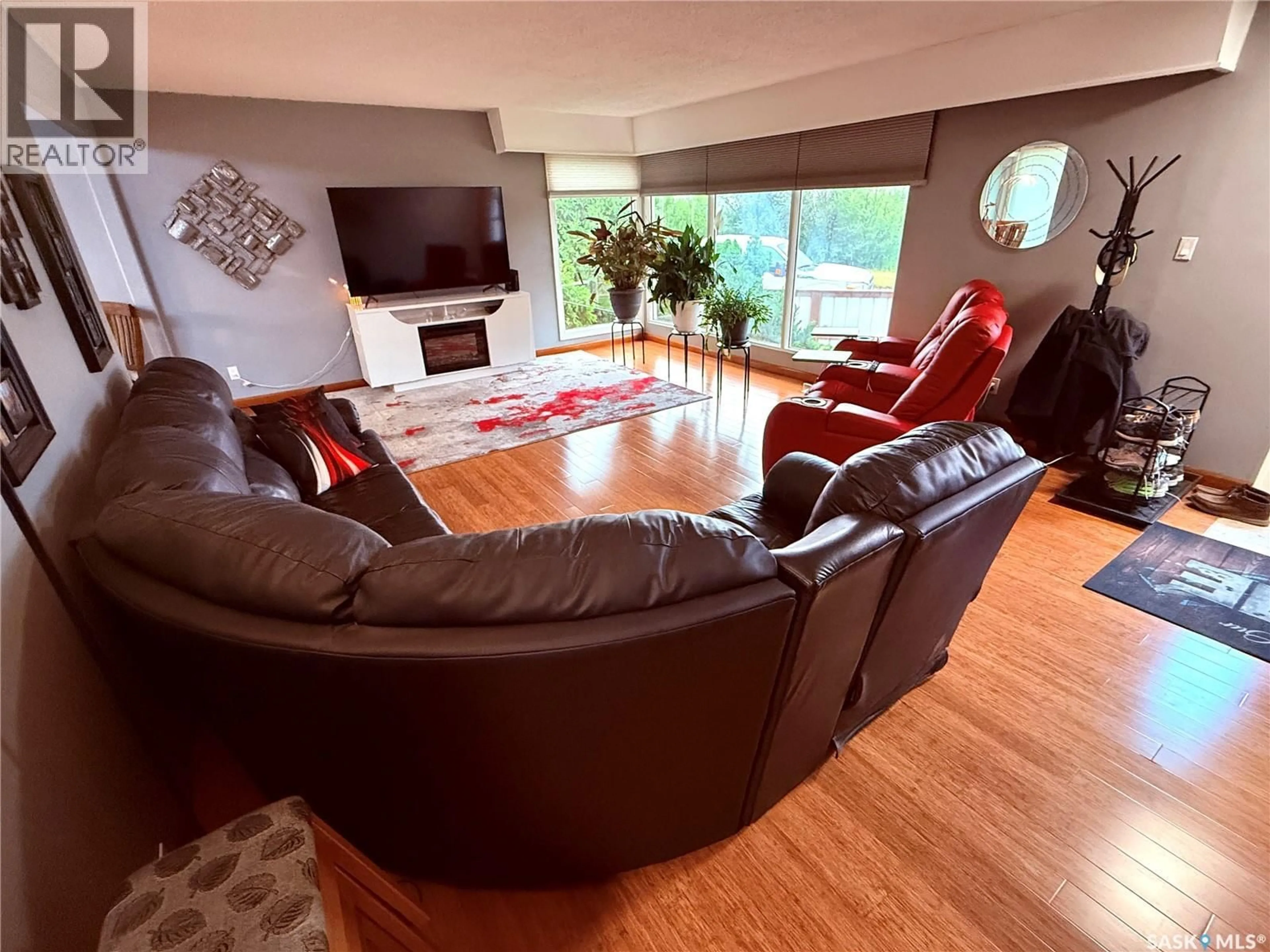 Living room with furniture, wood/laminate floor for 502 101ST STREET, North Battleford Saskatchewan S9A0Y6