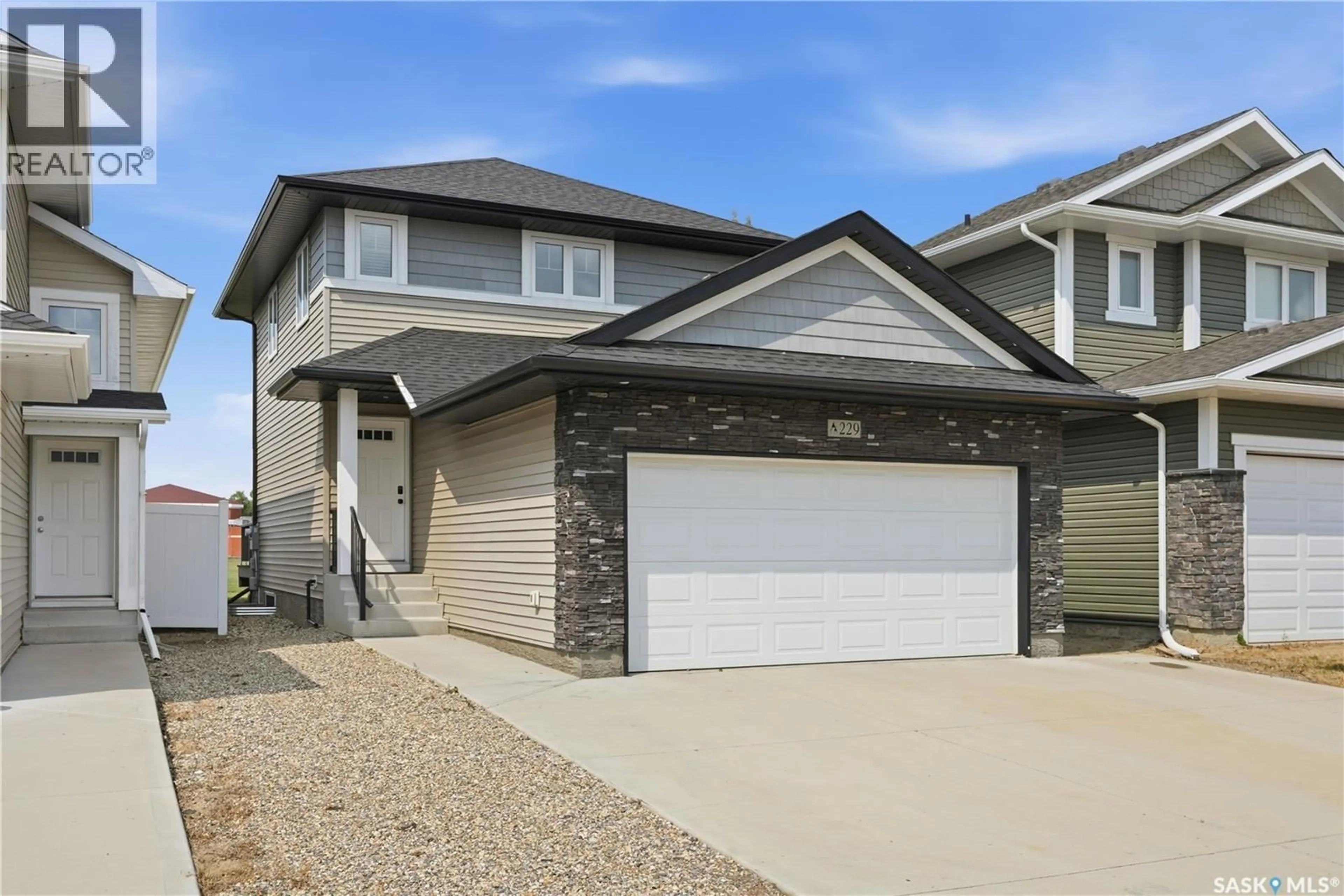 Home with vinyl exterior material, street for 229 WALL STREET, Dalmeny Saskatchewan S0K1E0