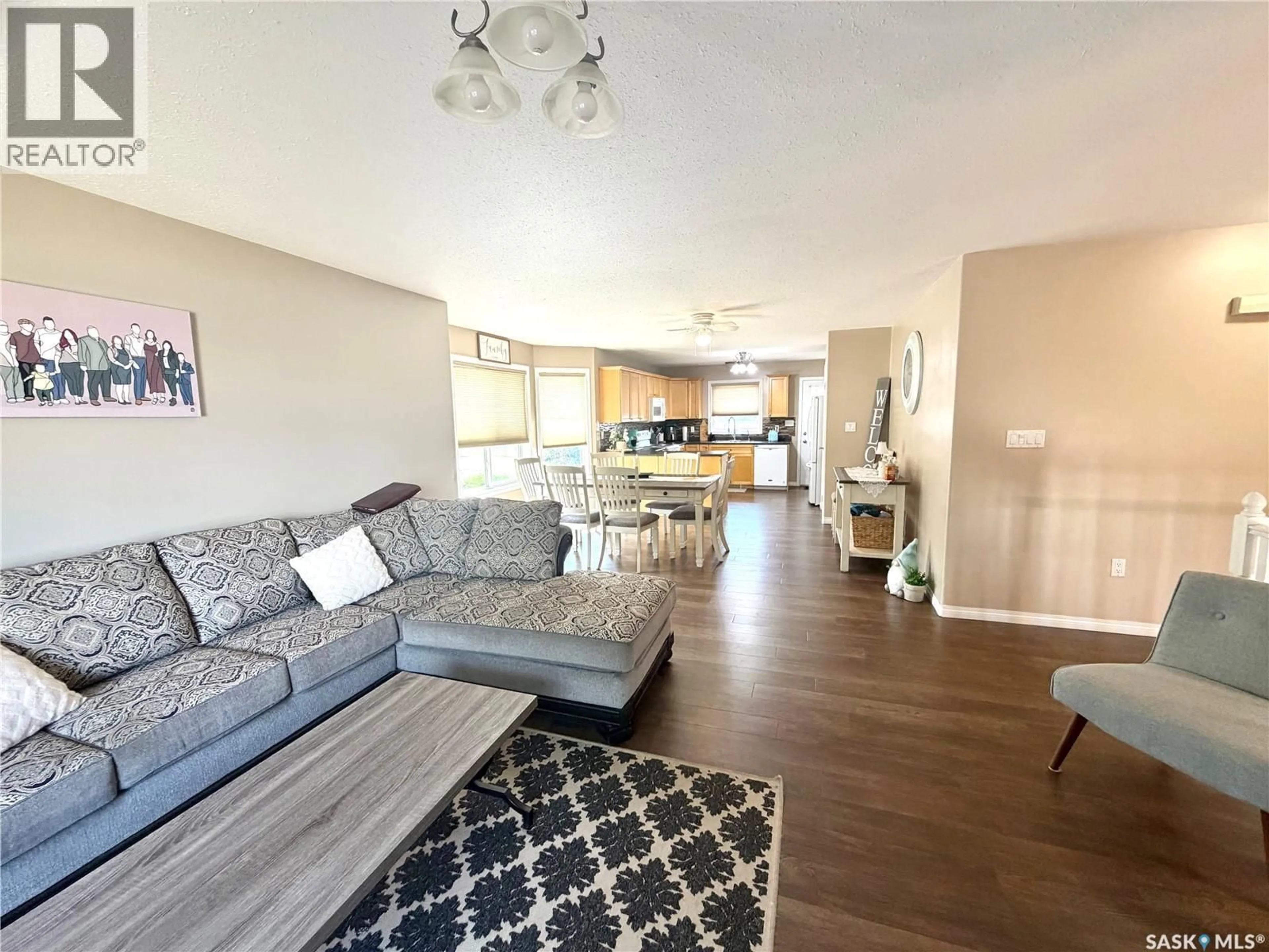 Living room with furniture, wood/laminate floor for 10339 BUNCE CRESCENT, North Battleford Saskatchewan S9A3Y4