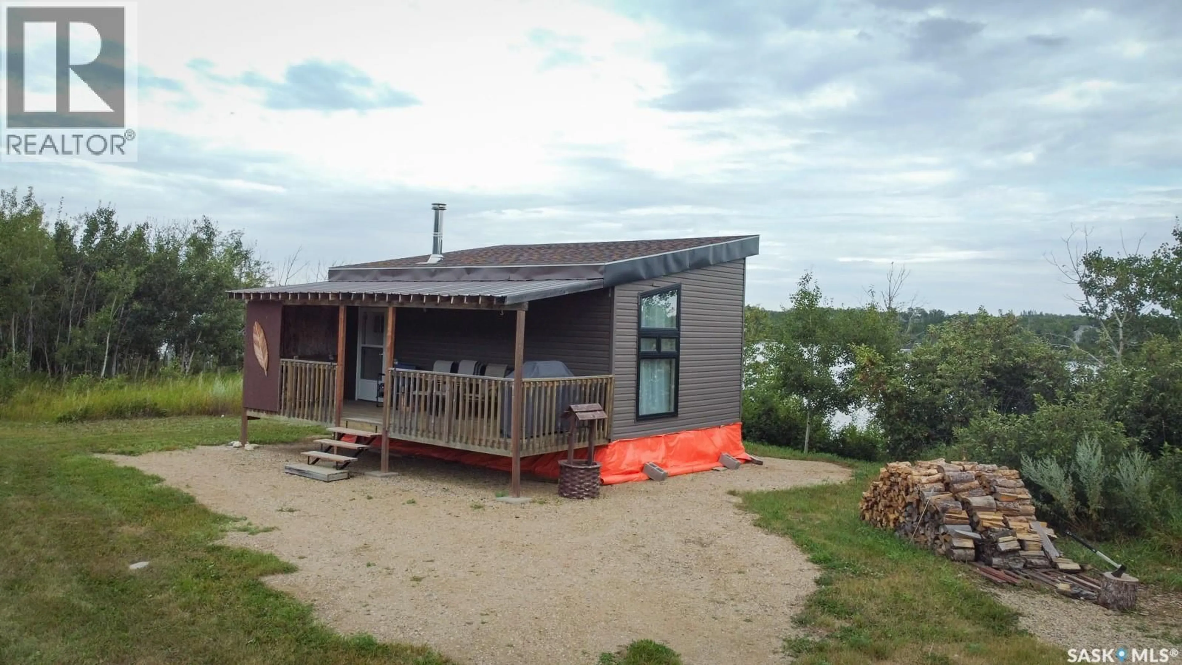 A pic from outside/outdoor area/front of a property/back of a property/a pic from drone, water/lake/river/ocean view for 301 BOISSIERE DRIVE, Lenore Lake Saskatchewan S0K3V0