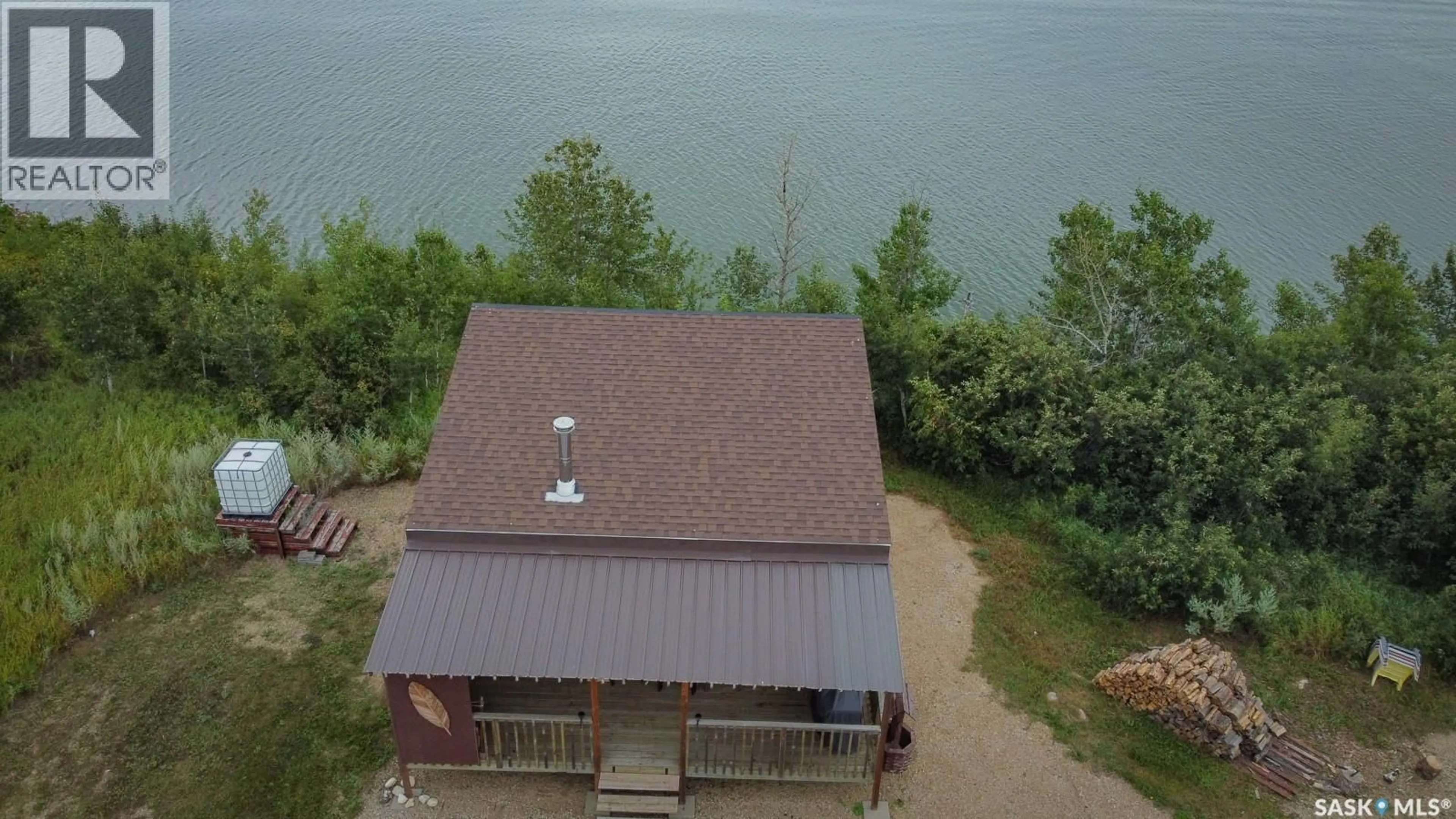 A pic from outside/outdoor area/front of a property/back of a property/a pic from drone, water/lake/river/ocean view for 301 BOISSIERE DRIVE, Lenore Lake Saskatchewan S0K3V0