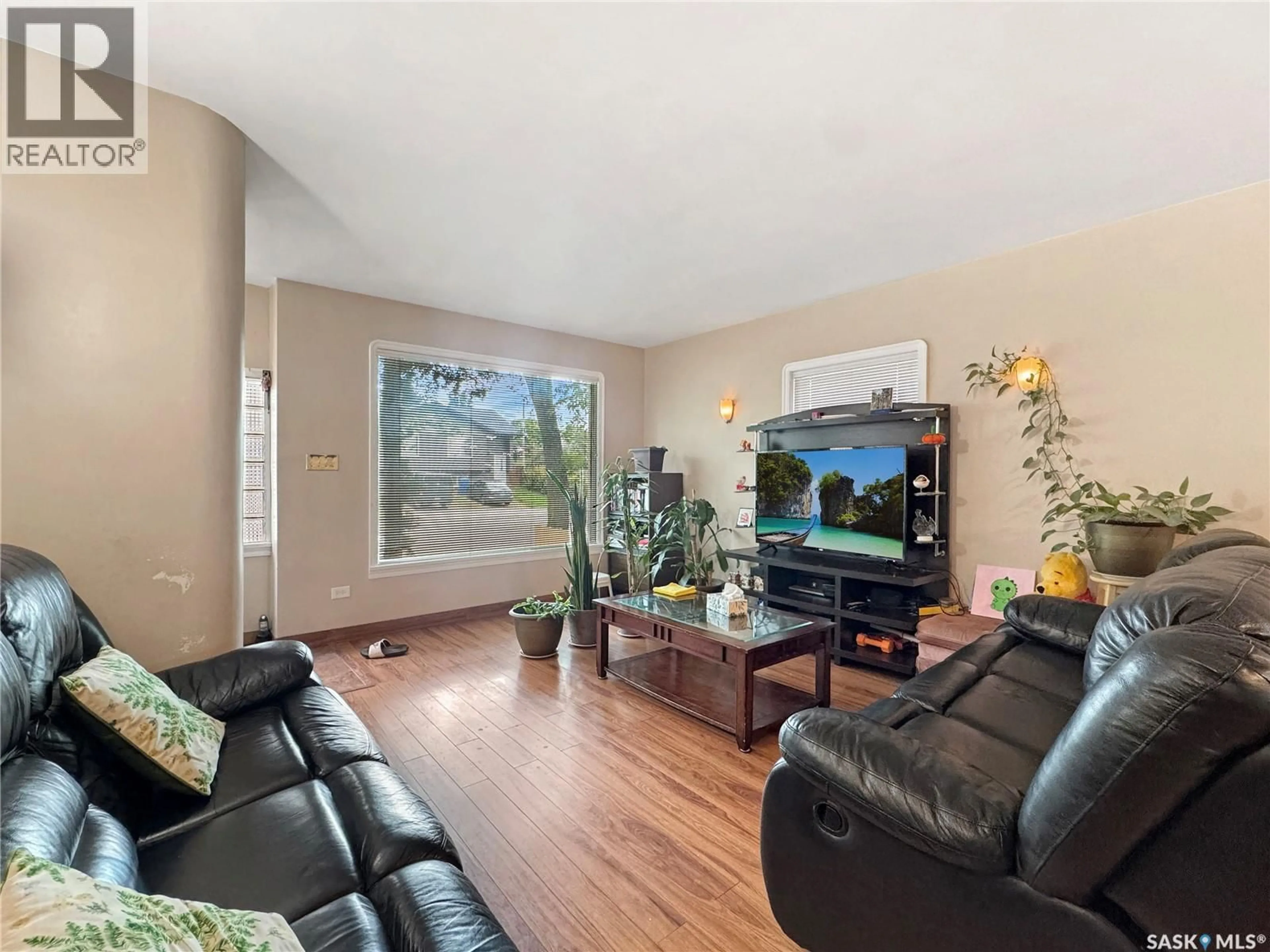 Living room with furniture, wood/laminate floor for 1021 105TH STREET, North Battleford Saskatchewan S9A1S4
