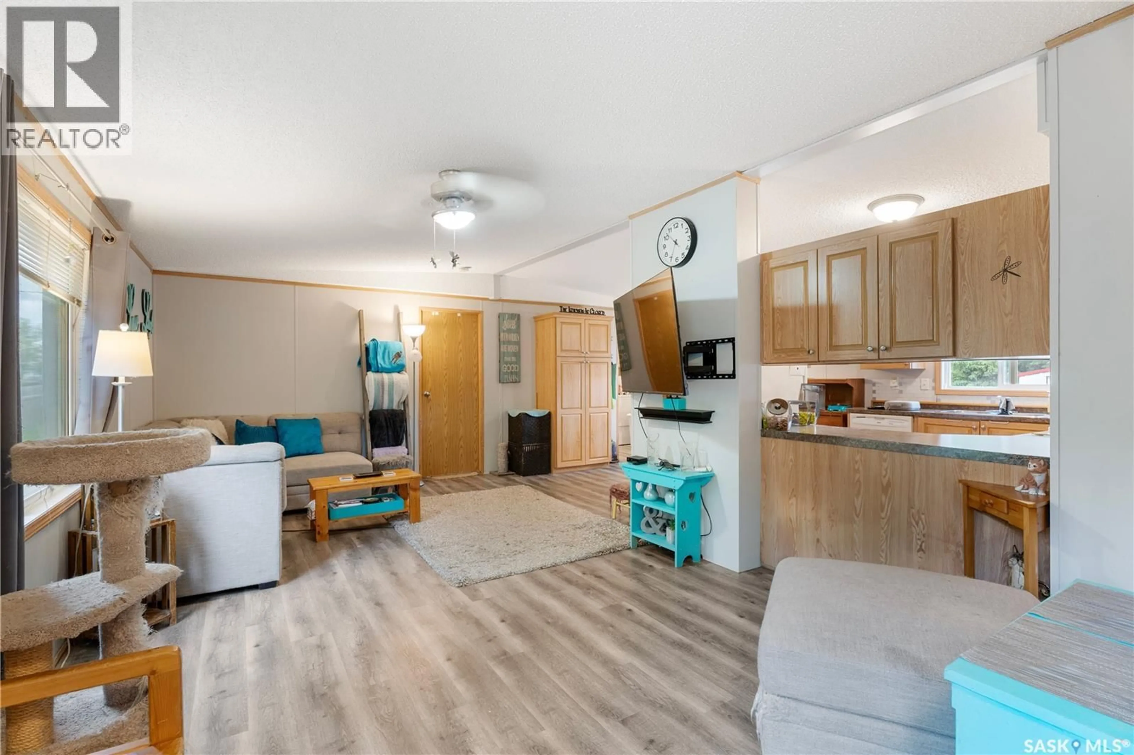 Living room with furniture, wood/laminate floor for 309 BURROWS AVENUE, Melfort Saskatchewan S0E1A0