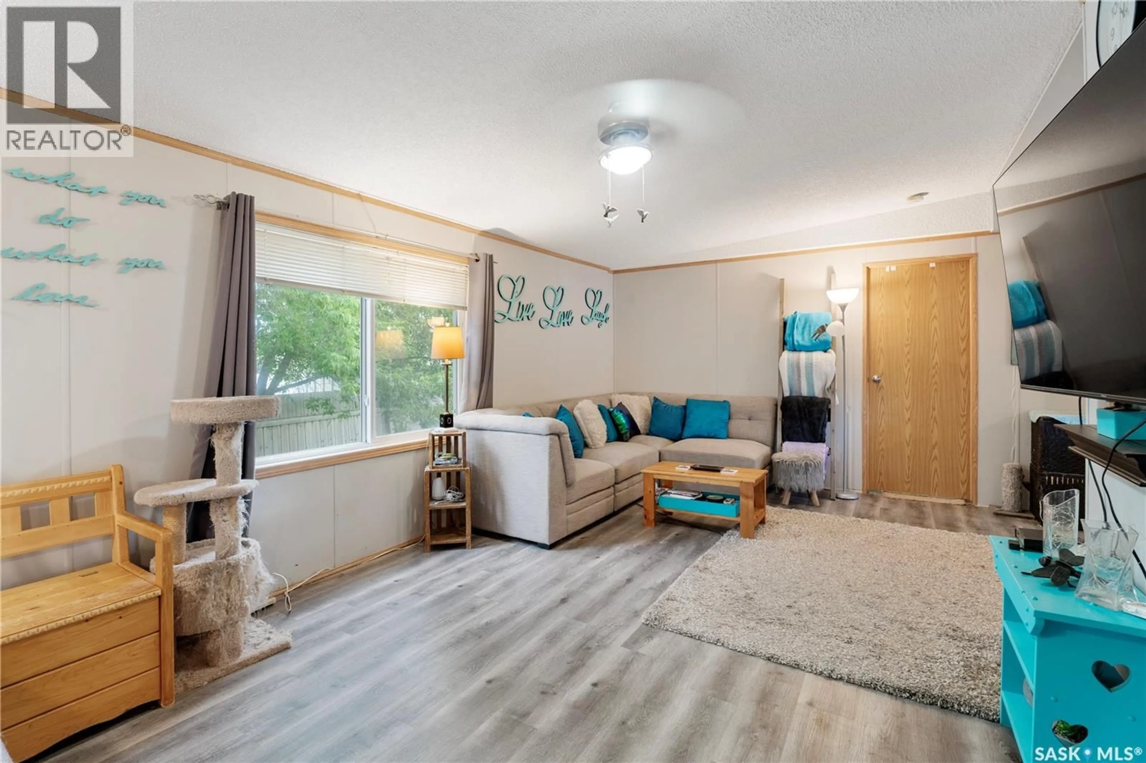 Living room with furniture, wood/laminate floor for 309 BURROWS AVENUE, Melfort Saskatchewan S0E1A0