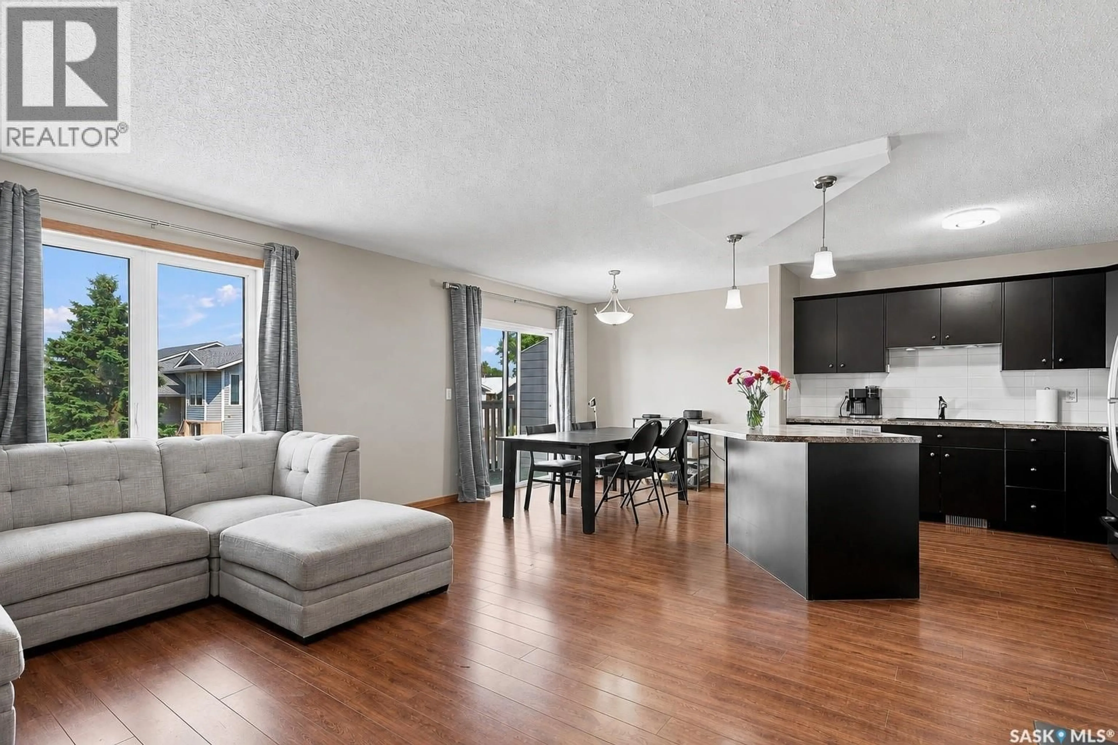 Living room with furniture, wood/laminate floor for 615 PETERS STREET, Warman Saskatchewan S0K4S0