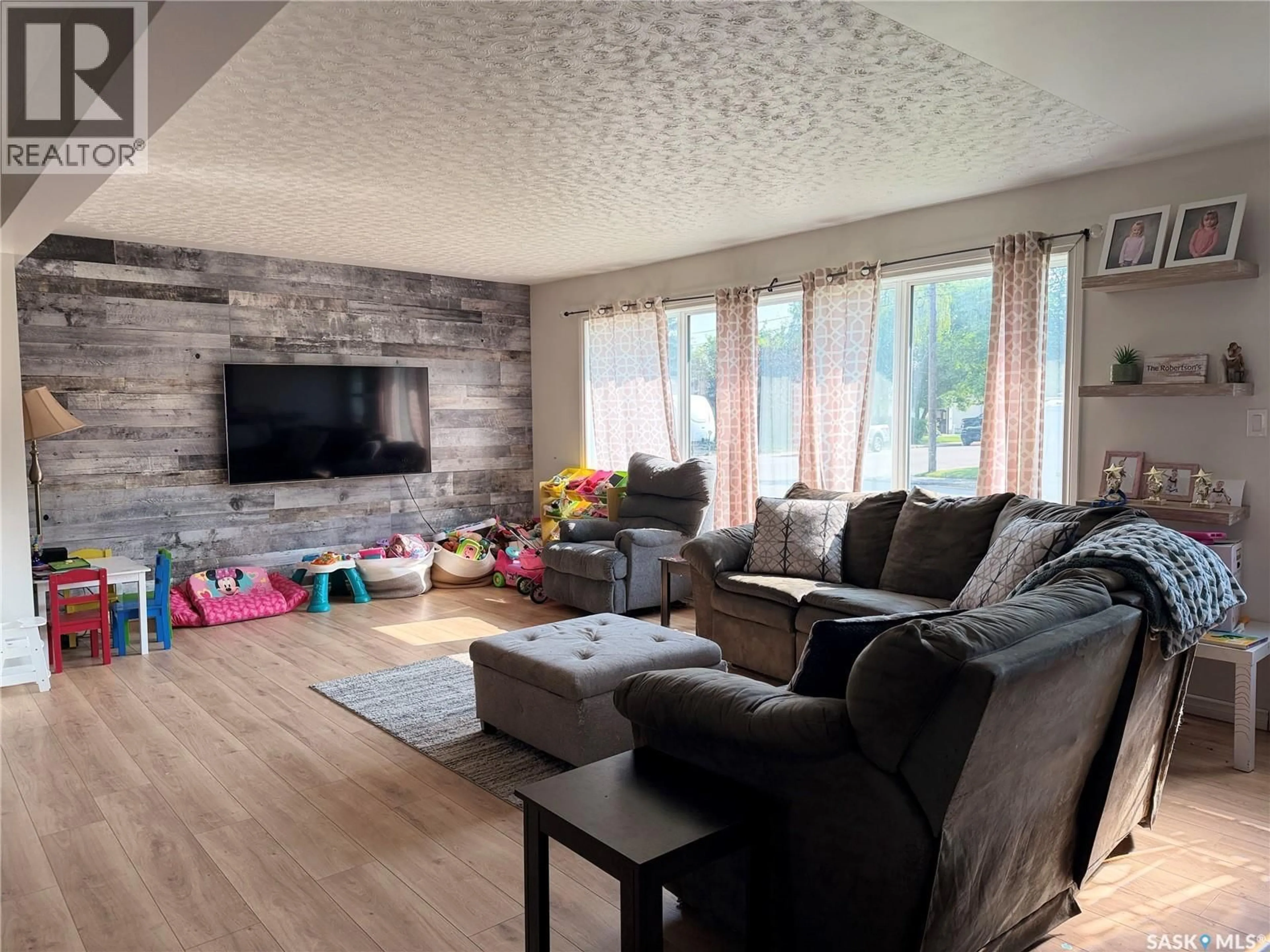 Living room with furniture, wood/laminate floor for 939 7TH STREET, Humboldt Saskatchewan S0K2A0